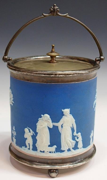 WEDGEWOOD BLUE JASPERWARE BISCUIT BARREL: Wedgwood jasperware biscuit barrel of cylindrical form, a blue ground decorated with classical figures in relief, silver plate fittings, raised on three ball feet, 6"h, 5.75"diam, 2.5lbs Start Price: