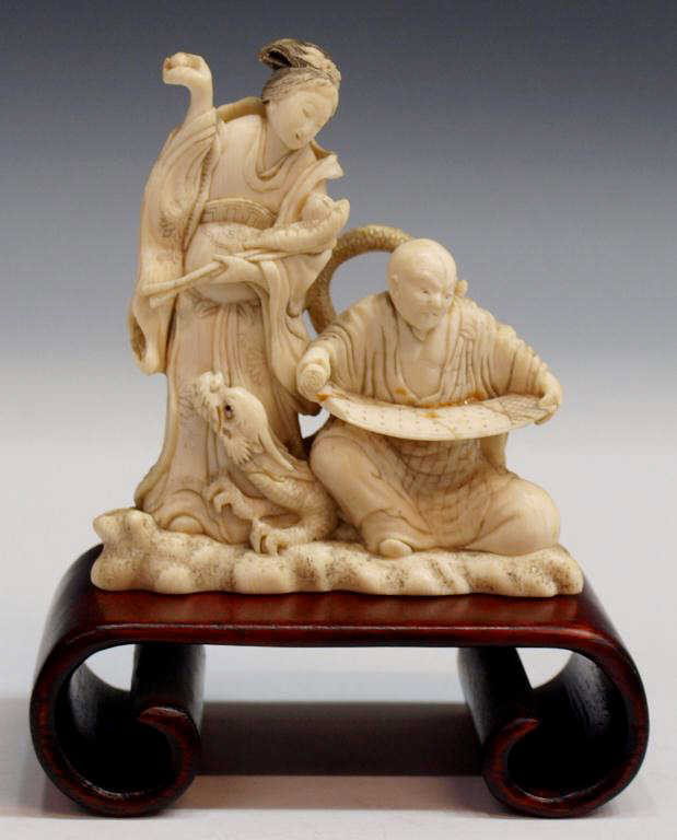 ANTIQUE JAPANESE CARVED IVORY FIGURAL GROUP DRAGON: **This item will not be shipped Internationally** Japanese carved ivory figural group of an arhat (Buddhist holy man) reading a scroll while accompanied by his companion dragon, all watched by a celes