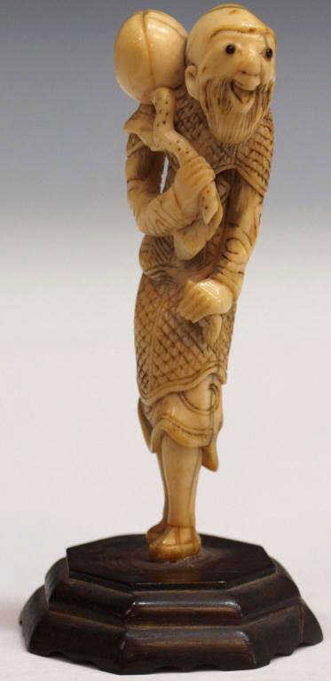 ANTIQUE JAPANESE IVORY NETSUKE OF A FOREIGNER: Japanese tinted ivory sashi-type netsuke of a foreigner, likely Edo period, 18th c., 3"h Start Price: $200.00