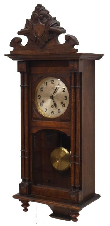 GUSTAV BECKER WALNUT CASED WALL CLOCK: German wall clock, time, strike chiming works by Gustav Becker, operating, considerable scratching at clock face, 37"h, 15"w, 9"d, 21.5lbs Start Price: $150.00
