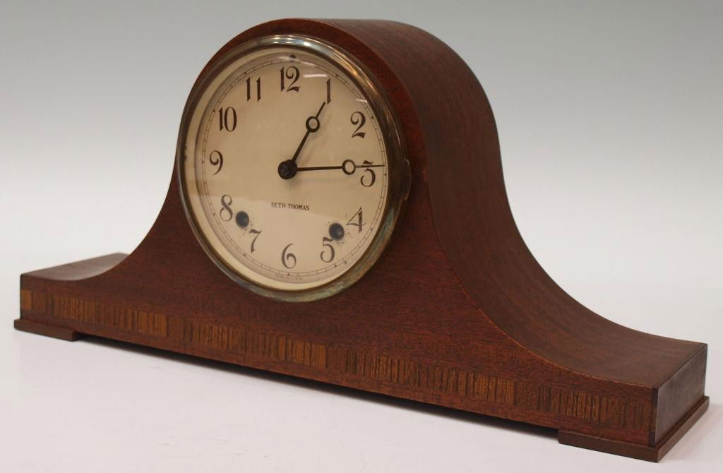 SETH THOMAS MANTLE CLOCK: Seth Thomas mantle clock, mahogany case with banded inlay at lower front, time and strike works, 8.25"h, 16.75"w, 4"d Start Price: $50.00