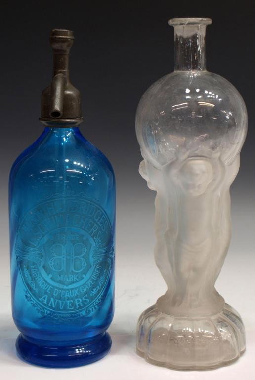 ANTIQUE BLUE GLASS SELTZER BOTTLE & FIGURAL BOTTLE: (lot of 2) Bottles: (1) seltzer bottle in blue 'Maison H.J. Bridges - L. Schumachers Anvers', old chip at base, 12"h; (1) colorless and frosted glass bottle, the bulbous upper portion supported by put