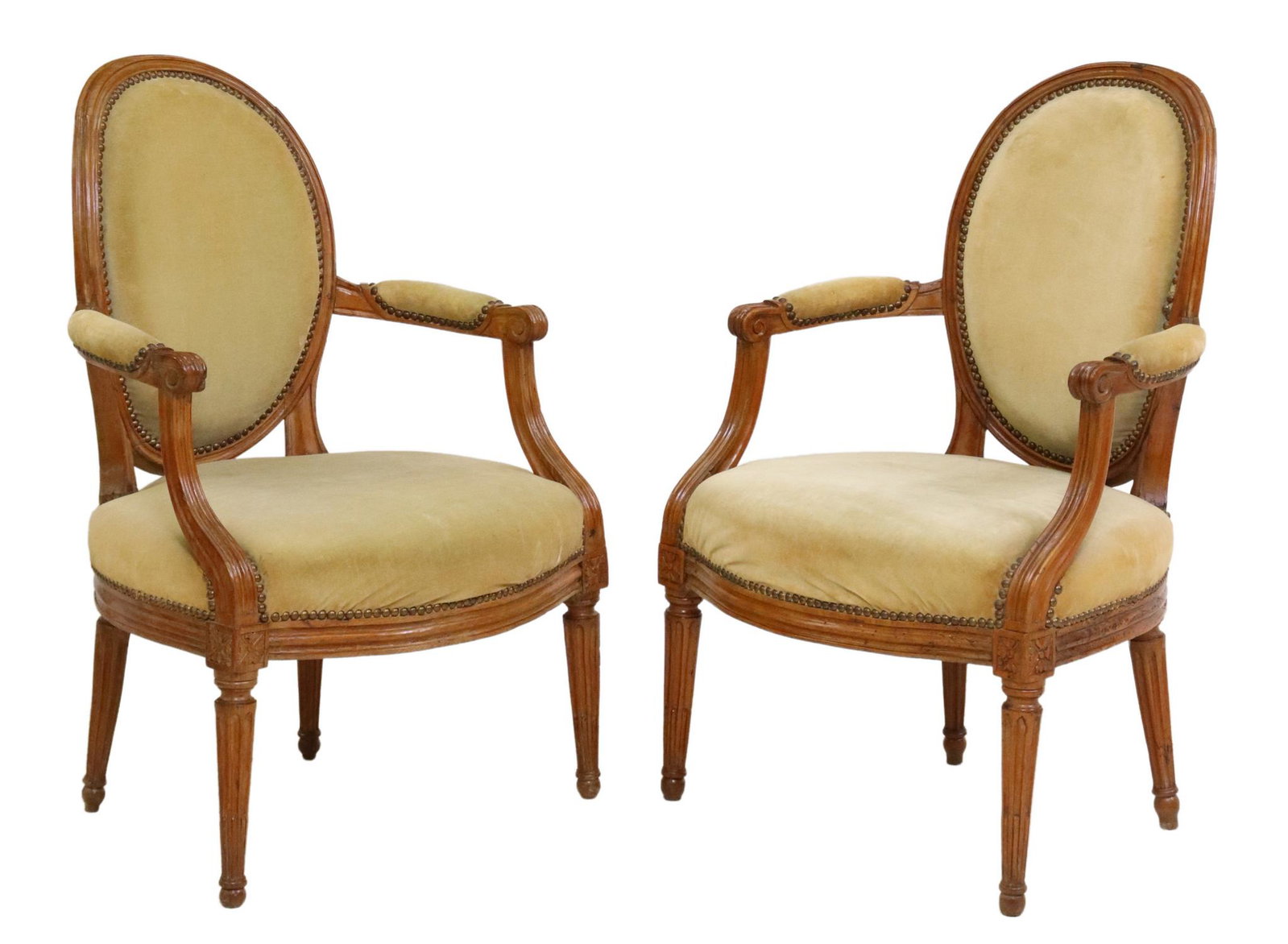 2) LOUIS XVI STYLE UPHOLSTERED OVAL-BACK FAUTEUILS: (pair) Louis XVI style armchairs, 20th c., oval medallion back, in velvet upholstery, with nailhead trim, scrolled handholds, rising on fluted tapered legs, approx 35"h, 23"w, 19.5"d, seat height: app