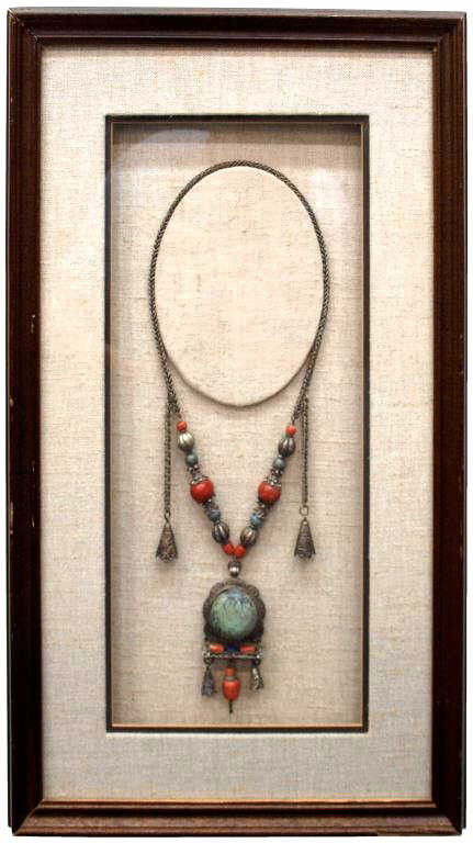 CHINESE SILVER, TURQUIOISE, CORAL & LAPIS NECKLACE: Substantial Antique Chinese silver necklace featuring a large central turquoise stone, hand worked silver and filigree work with turquoise, coral, lapis silver beads and bells, framed: 25"h, 15"w, 6.2