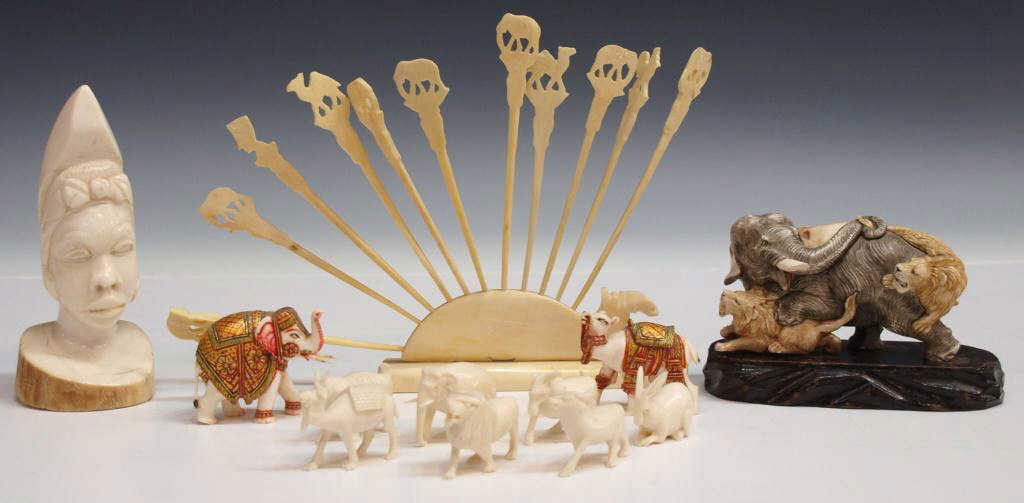AFRICAN & OTHER CARVED IVORY FIGURES & ELEPHANT: **This lot will not be shipped Internationally** (lot of 23) Collection of carved ivory pieces including: (1) African tribal bust, 4.75öh; (1) tinted figural group carved as an elephant being attacke