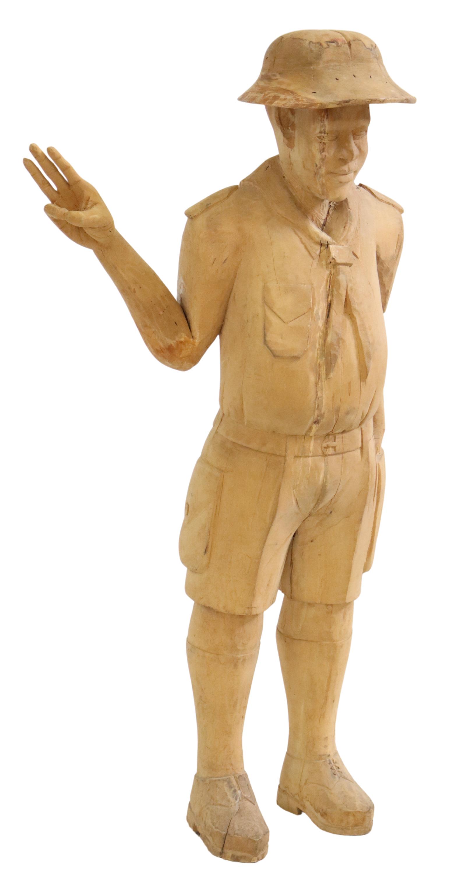 CARVED WOOD STANDING MALE FIGURE, 50.5"H: Carved wood figure, 20th c., in uniform style dress, one hand raised in three-finger salute, approx 50.5"h Start Price: $150.00