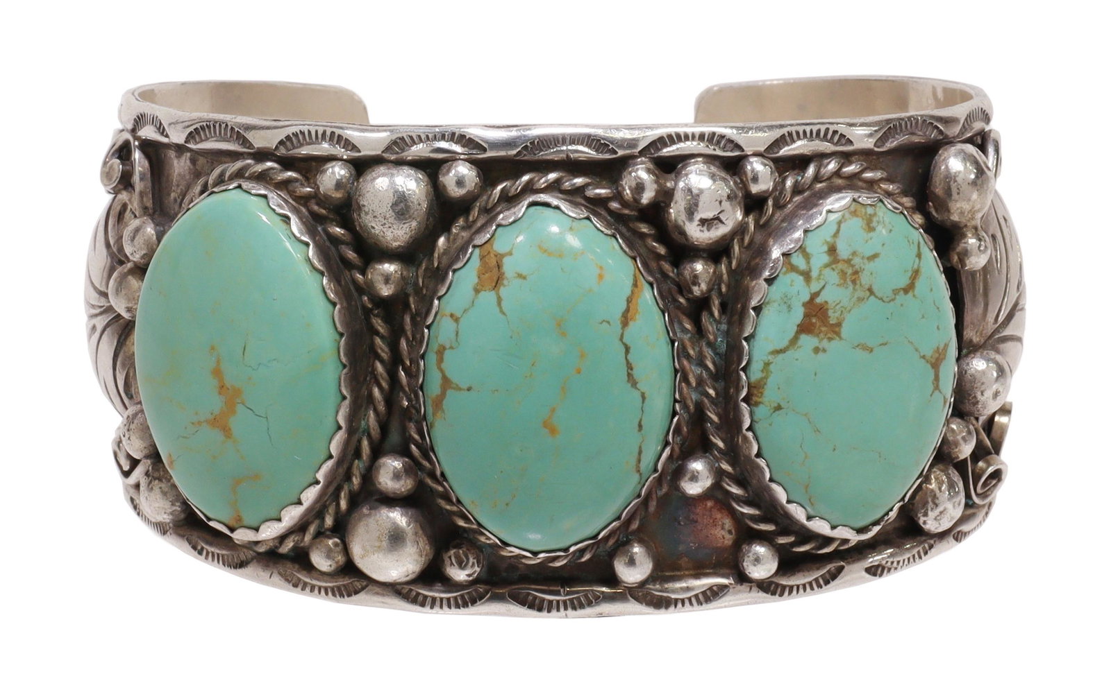 NATIVE AMERICAN SILVER & TURQUOISE CUFF BRACELET: Native American sterling silver cuff bracelet, signed L, possibly Larry Begay (Navajo/ Dine, 20th c.), rimmed with stampwork the wide cuff features a feather, scroll and bead motif (lacking one bead a