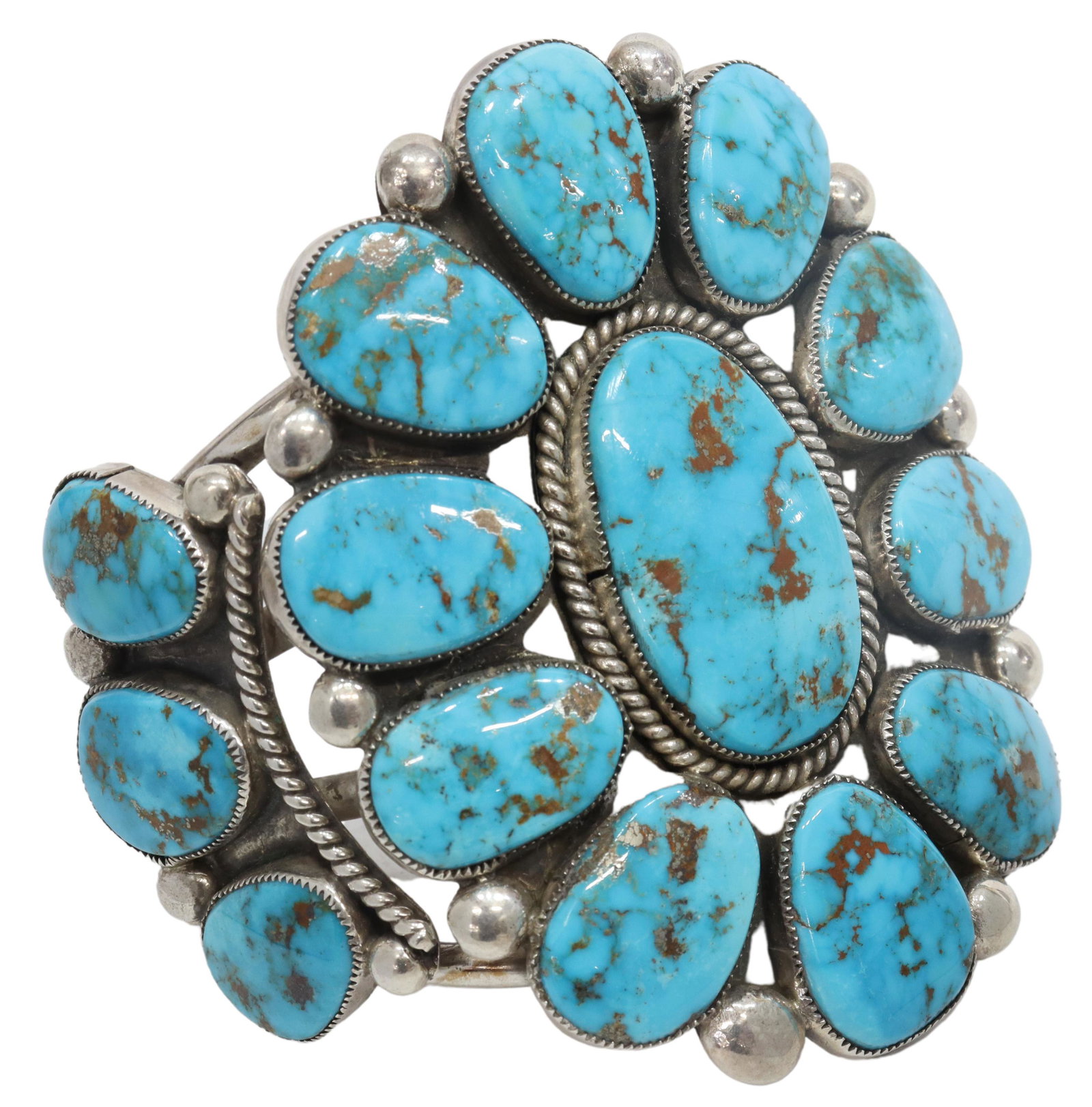 ROBERT & BERNICE LEEKYA TURQUOISE CLUSTER CUFF: Native American sterling silver cuff bracelet, Robert Leekya (Zuni Pueblo, 1934-2019) and Bernice Leekya (Zuni Pueblo, b.1930s), central plaque with radiating clusters of turquoise, approx 3 5/8"w, in