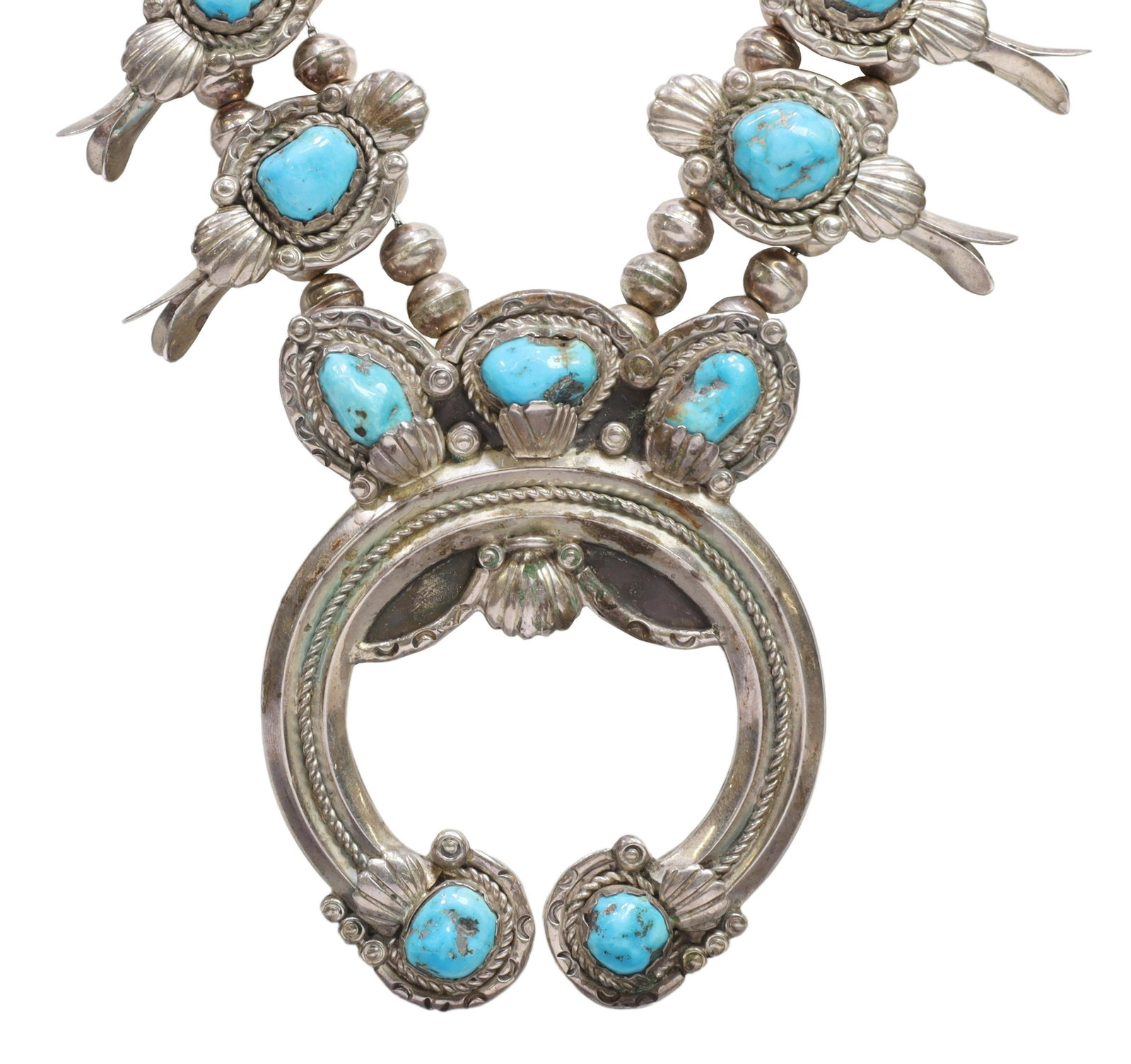 NATIVE AMERICAN TURQUOISE SQUASH BLOSSOM NECKLACE: Native American silver (content unknown) squash blossom necklace, engraved signature Rose Mary Charley (Navajo/ Dine, 20th c.), twelve blossoms, each set with a turquoise stone, central naja pendant, 