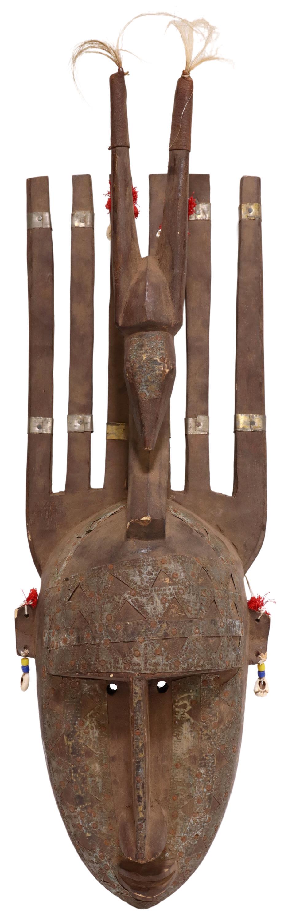 MALI BAMBARA PEOPLES AFRICAN CARVED WOOD MASK: African carved wood mask, Bambara peoples, Mali, having six vertical elements, with carved antelope, atop elongated face, bead, hair, and shell accents, approx 26.5"h, 9.5"w, 4.5"d, 4.5lbs Start Price