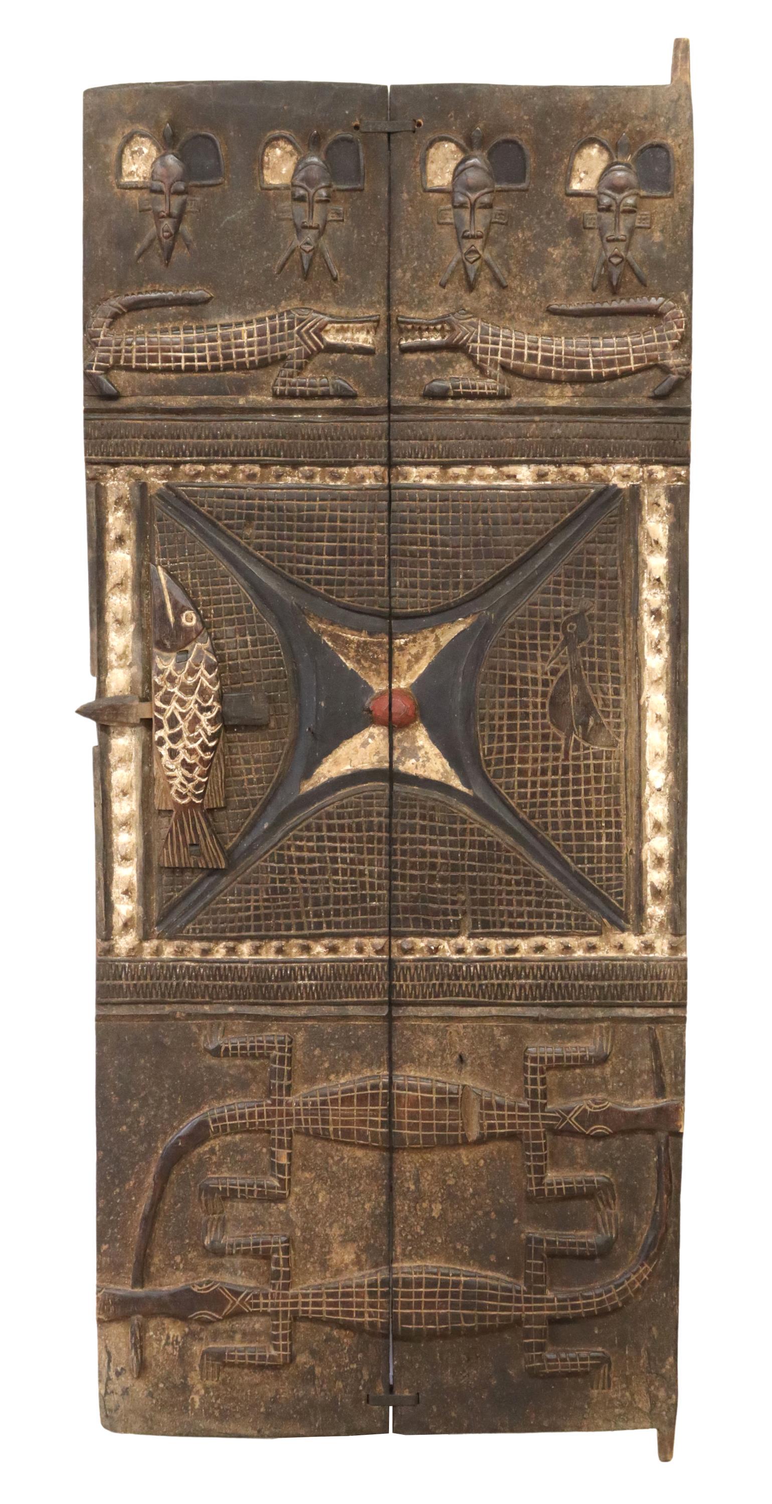 AFRICAN PANELED GRANARY DOOR, POSSIBLY DOGON: African paneled granary door, possibly the Dogon peoples, Mali and Burkina Faso, polychrome pigment, ornamented with figural masks and crocodiles, slide lock in the form of a fish, approx 63.5"h, 26.2