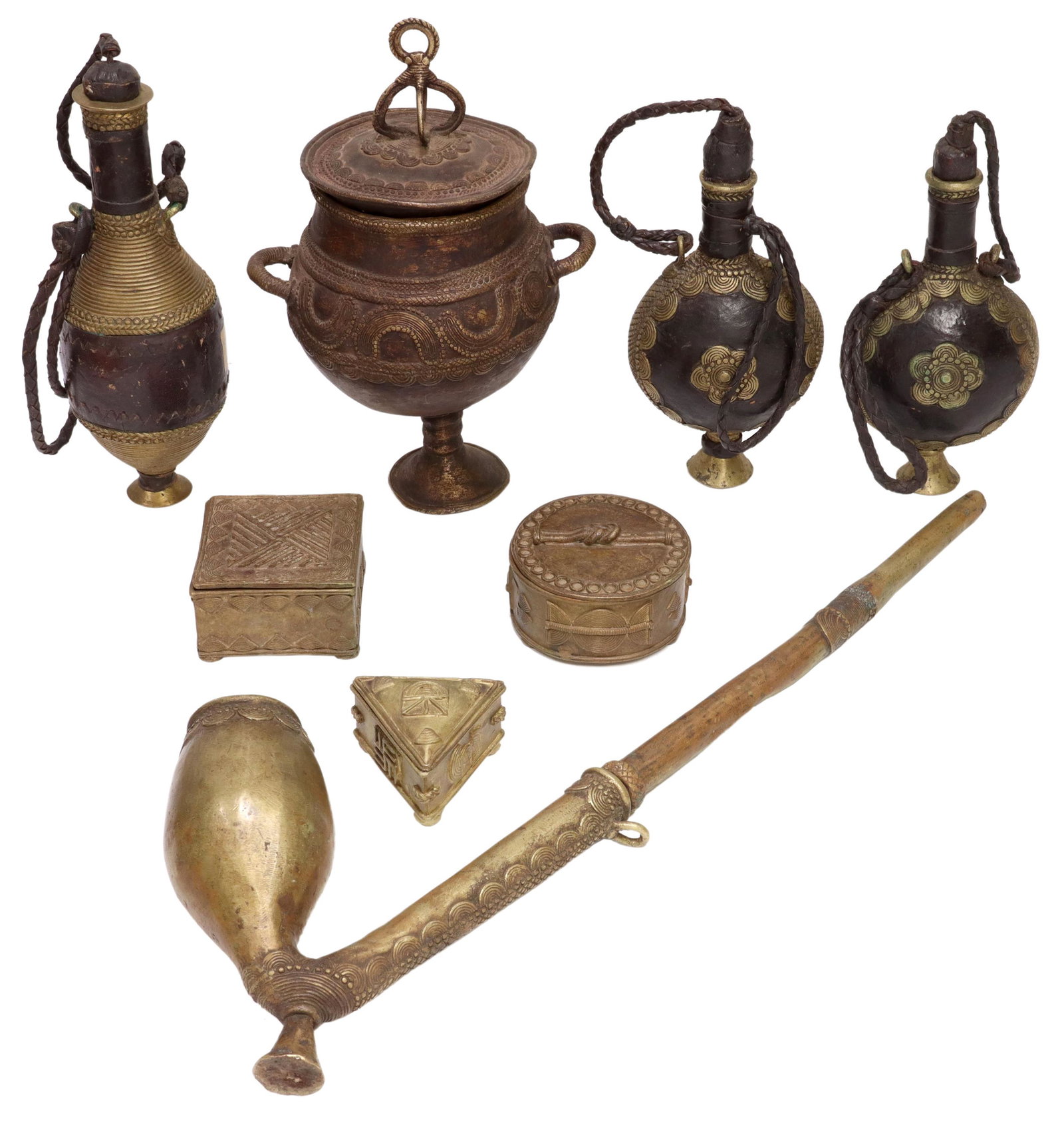 (8) AFRICAN METAL TABLE ITEMS, FLASKS, PIPE, BOXES: (lot of 8) African patinated and gilt metal table items, possibly West Africa all with incised concentric rings and varying geometric designs, including: (1) long pipe, with large bowl; (1) two-handle