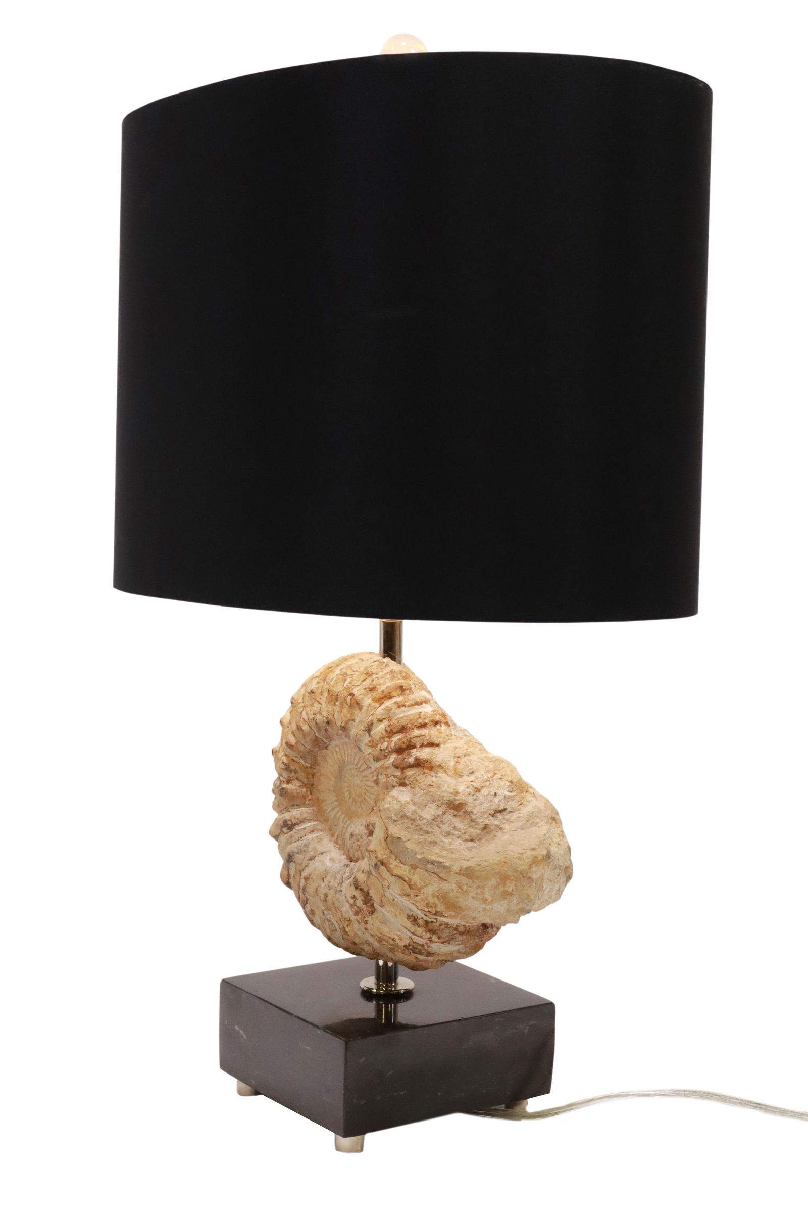 AMMONITE FOSSIL SPECIMEN TABLE LAMP ON MARBLE BASE: Ammonite fossil specimen, Morocco, now fashioned as a table lamp, mounted on black marble base, accompanied by black fabric drum shade, fossil: approx 6"h, 8"w, 3"d, overall: approx 21"h, 14"w, 9"d, 1