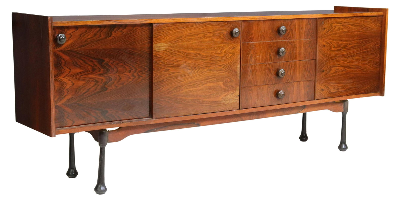 ITALIAN MID-CENTURY MODERN ROSEWOOD SIDEBOARD: Italian mid-century modern rosewood sideboard/ credenza, c.1960s, dual sliding doors, four drawers, single-door cabinet, interior shelves, rising on cylindrical legs with flared ends, approx 34.5"h, 8