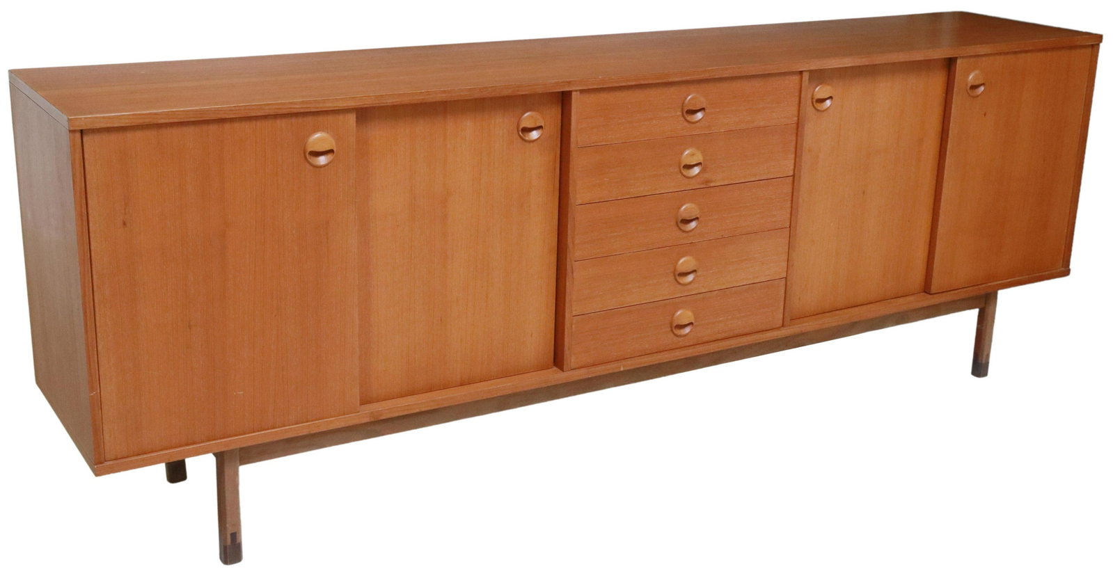 ITALIAN MID-CENTURY MODERN TEAK SIDEBOARD CREDENZA: Italian mid-century modern teak sideboard/ credenza, c.1950s, five centered drawers, flanked by hinged and sliding cabinet doors, interior shelves, rising on square legs, approx 30.5"h, 86.75"w, 17"d 