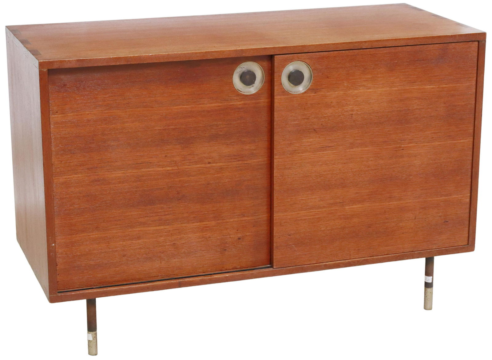ITALIAN MID-CENTURY MODERN TEAK CREDENZA CABINET: Italian mid-century modern teak credenza/ cabinet, from the "Select Series" by Rossi di Albizzate, c.1960s, having dual sliding cabinet doors, opening to shelved interior, rising on cylindrical steel