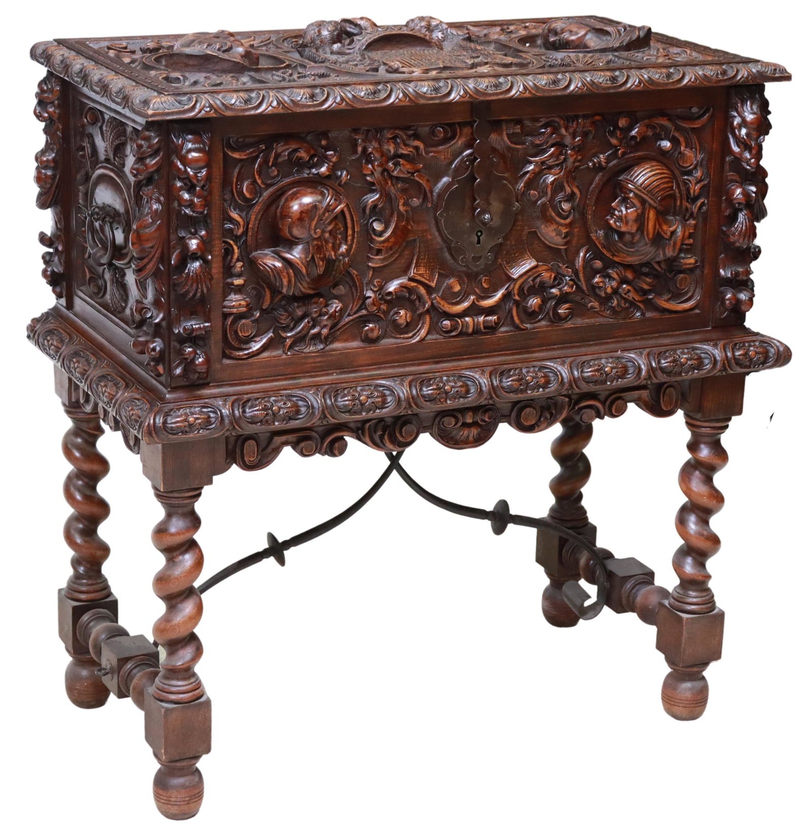 EXCEPTIONAL SPANISH RENAISSANCE REVIVAL CHEST: Spanish Renaissance Revival carved trunk on stand, early 20th c., heavily carved case with scrolling foliates and figural masks, central coat of arms to hinged lid, opening to storage interior, rising