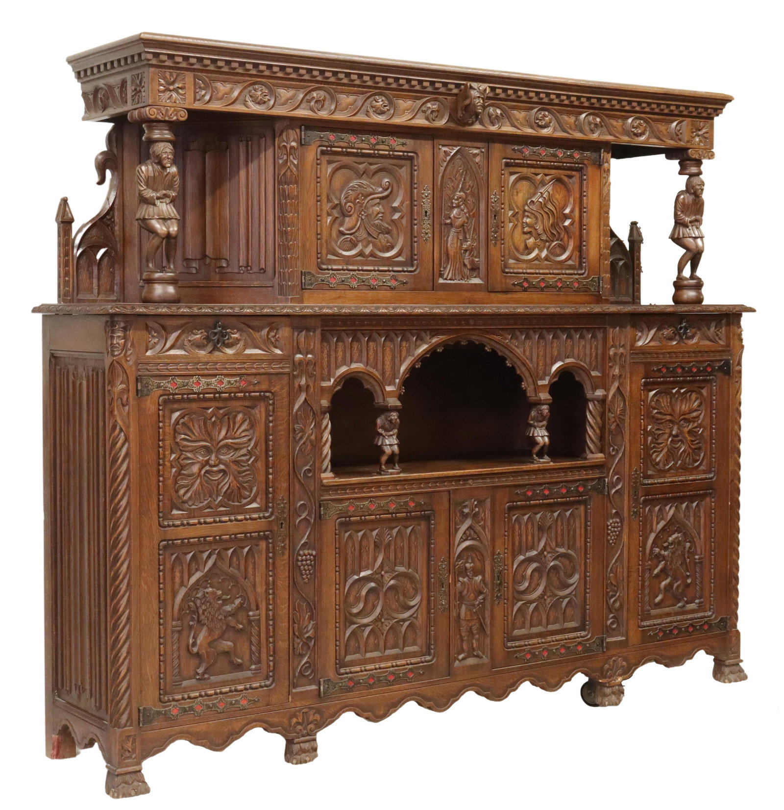 LARGE FIGURAL CARVED OAK CUPBOARD SIDEBOARD: Figural carved cupboard / sideboard, late 19th/ early 20th c., dentil cornice, over case heavily carved with protruding and full length figures and linenfold, having four small cabinet doors, centerin