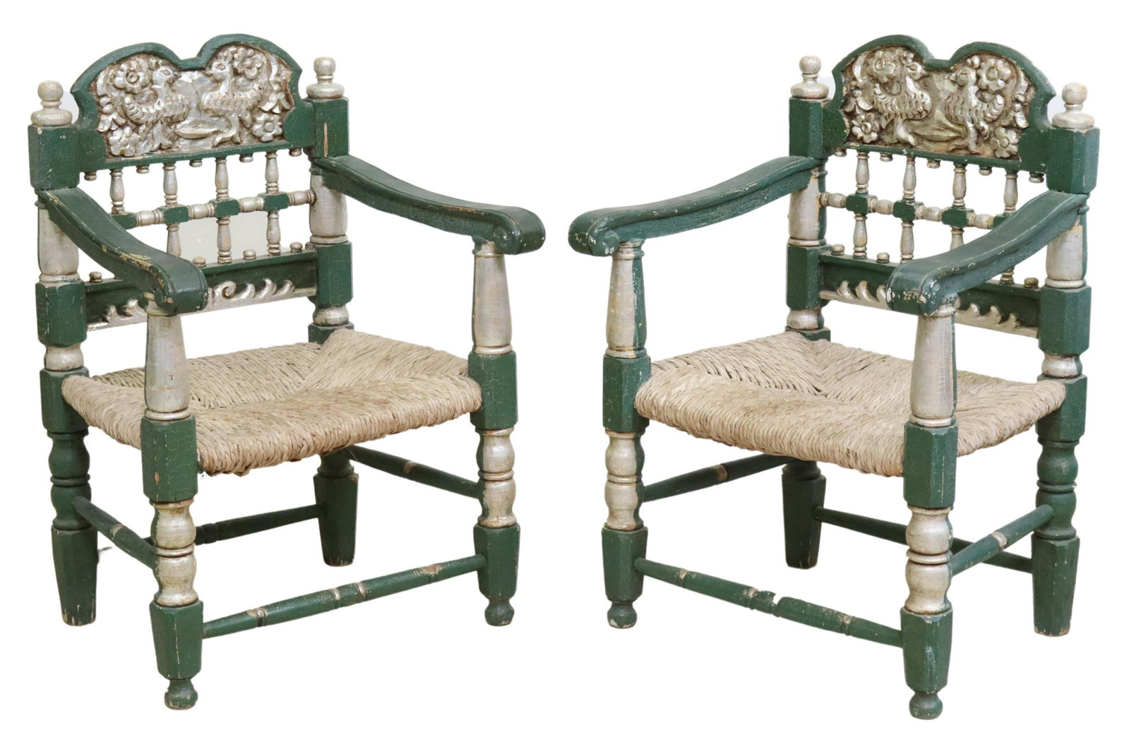 (2) SPANISH PARCEL GILT & PAINTED ARMCHAIRS: (pair) Spanish polychrome painted armchairs, early 20thc., having carved back featuring birds and florals, all in a green and silver gilt paint, scrolled handholds, over rush seat, rising on turned st