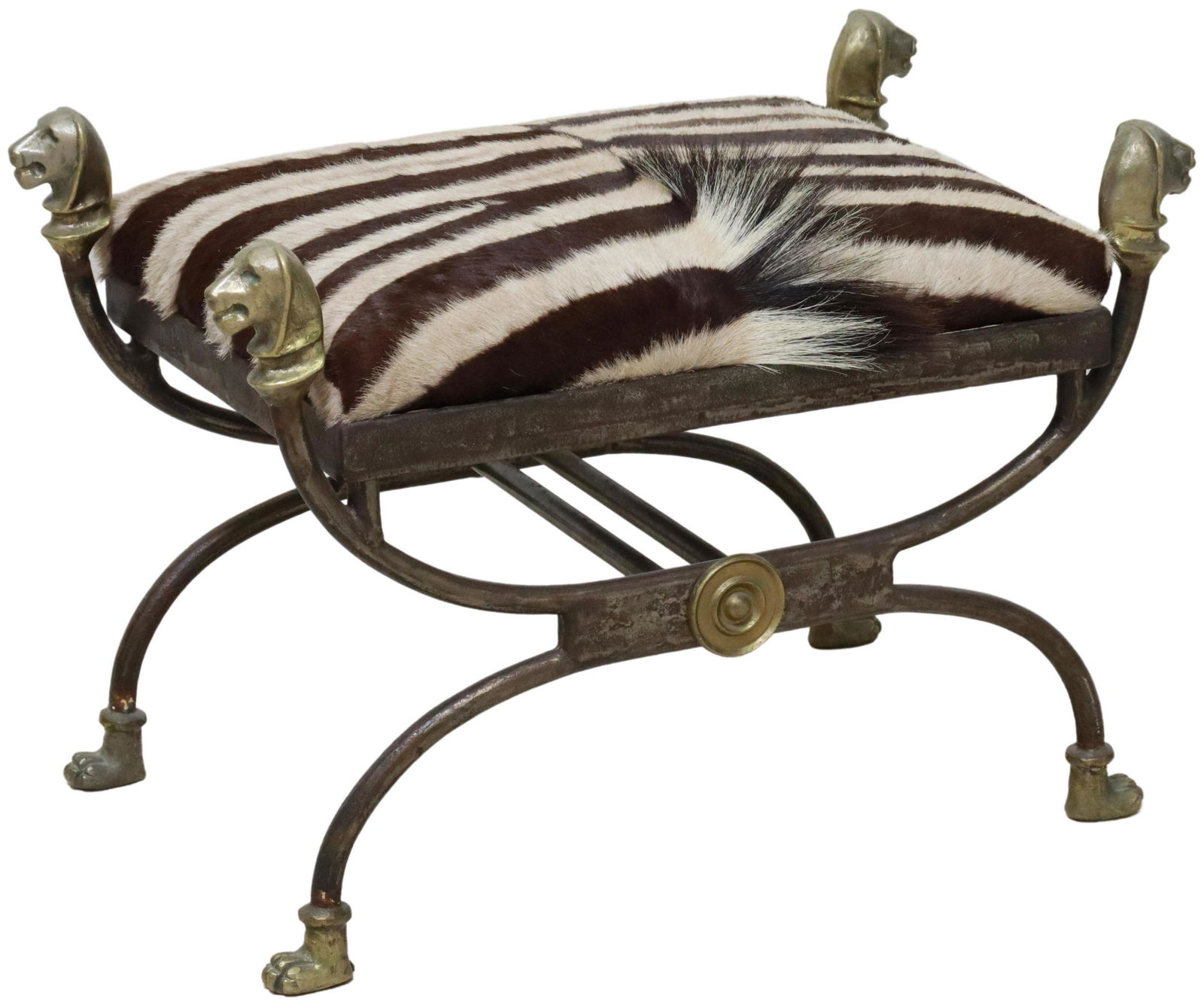 NEOCLASSICAL STYLE ZEBRA HIDE & IRON CURULE STOOL: Neoclassical style iron and gilt metal curule stool, attributed by consignor to Maitland-Smith, 20th c., having gilt metal dog head terminals, zebra hide upholstered seat, rising on iron curule base,
