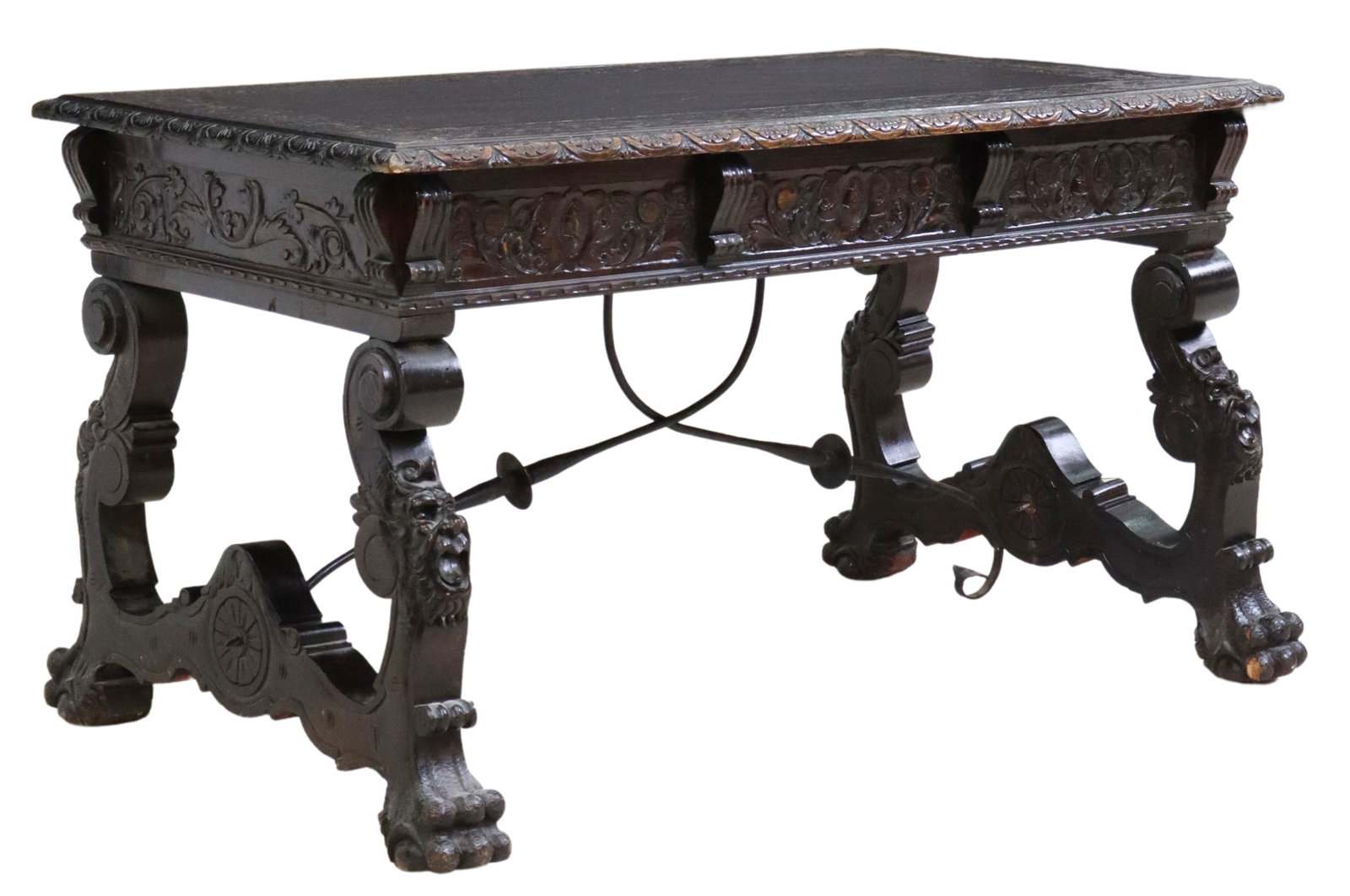 SPANISH RENAISSANCE REVIVAL LIBRARY DESK TABLE: Spanish Renaissance Revival library desk table, 19th c., having foliate carved top, with lunette border, three drawers, rising on ox yoke supports, faced with grotesques, ending on paw feet, approx 31