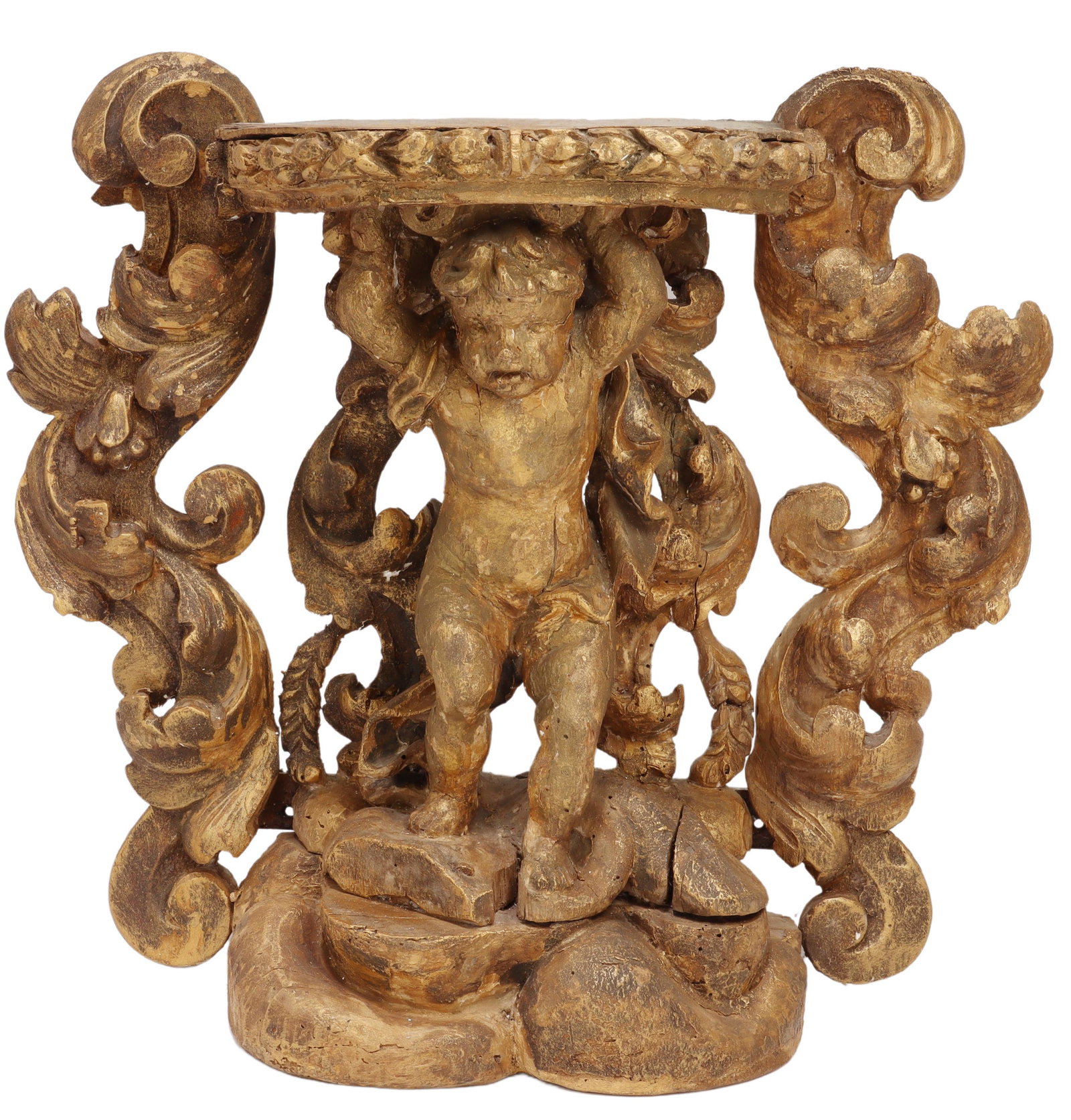 ITALIAN CARVED GILT PUTTO PEDESTAL, 17TH/ 18TH C.: Italian carved and gilt painted pedestal for a santo figure, 17th/ 18th c., central full-bodied putto holding up bracket top, flanked by scrolling foliates, rising on naturalistically modeled base, ap