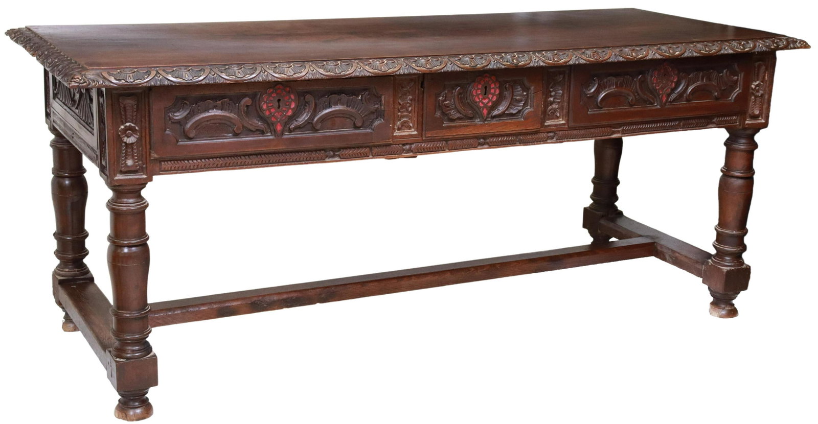 EXCEPTIONAL SPANISH BAROQUE CARVED LIBRARY TABLE: Spanish Baroque library table/ desk, 18th c., carved lunette border, with grotesque masks to corners, fitted with three drawers, red fabric backed escutcheons, rising on turned legs, joined with H-str