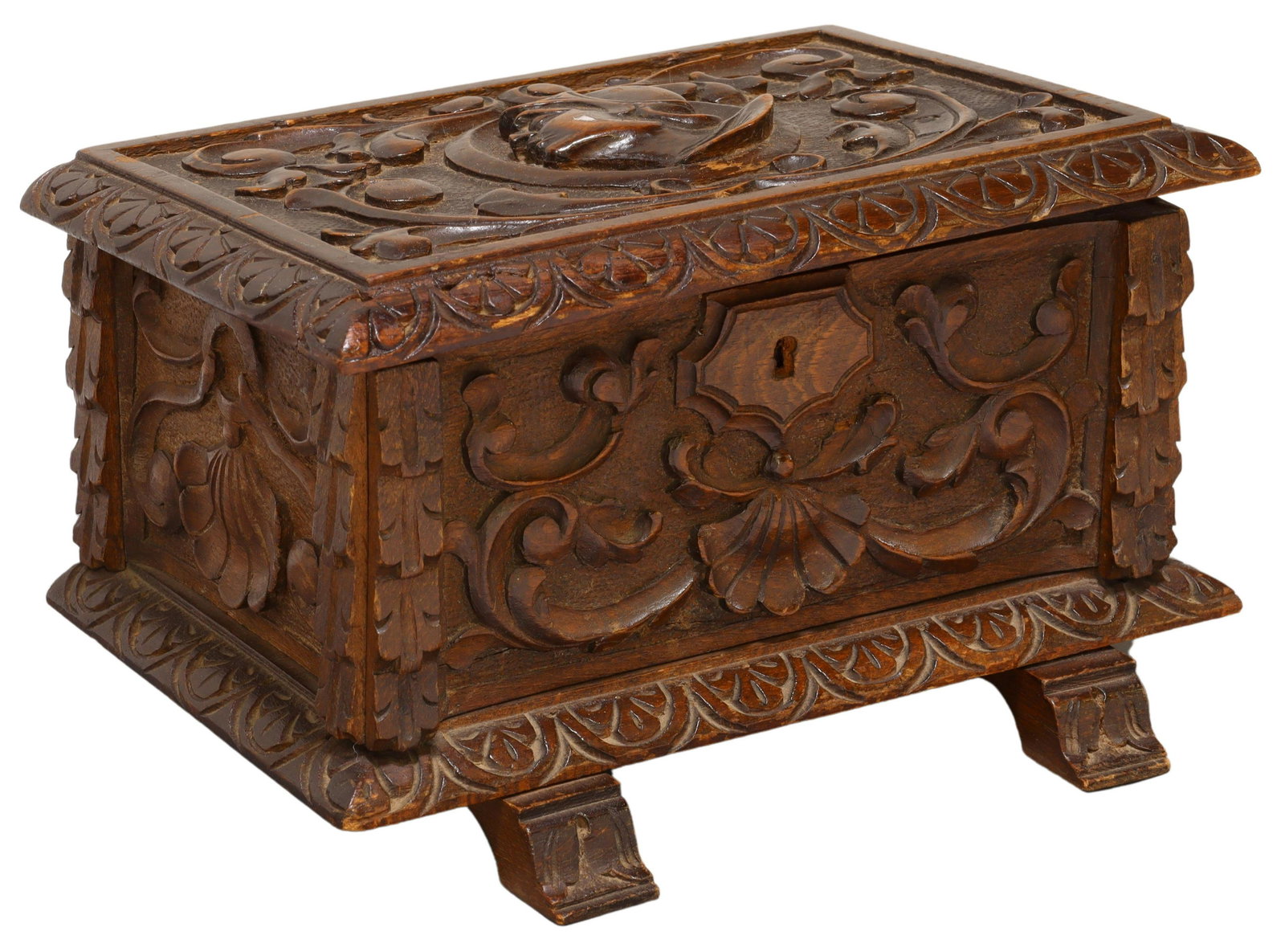 SPANISH RENAISSANCE STYLE CARVED TABLE BOX: Spanish Renaissance style table box, early 20th c., hinged lid carved with knight profile medallion, foliate scrolls, lined interior, rising on molded shoe feet, restoration to front left corner of li