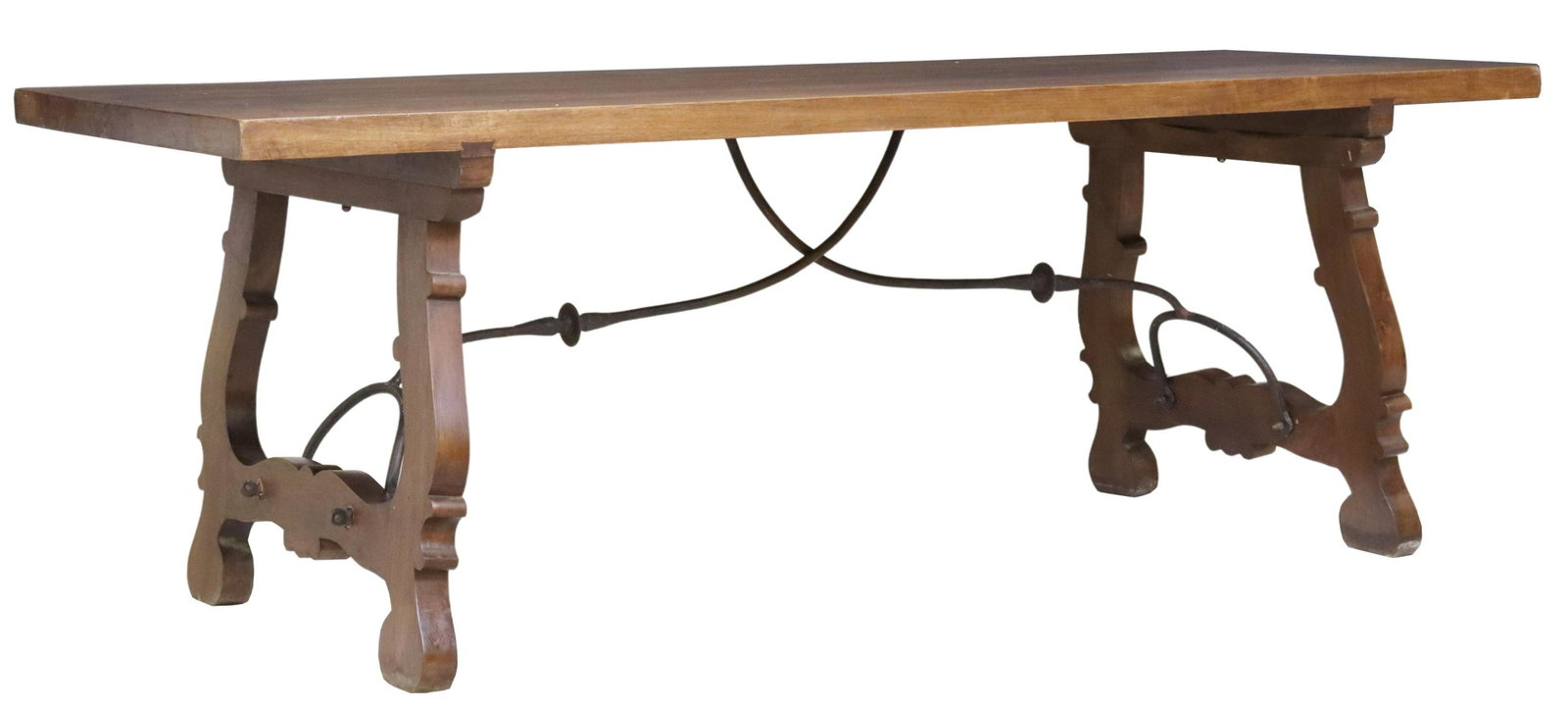 SPANISH BAROQUE STYLE WALNUT TABLE, 86"L: Spanish Baroque style walnut table, early 20th c., having 2" thick four-plank top, rising on ox yoke supports, joined with iron cross stretcher, evidence of old wood worm to top, approx 29.75"h, 86"l,