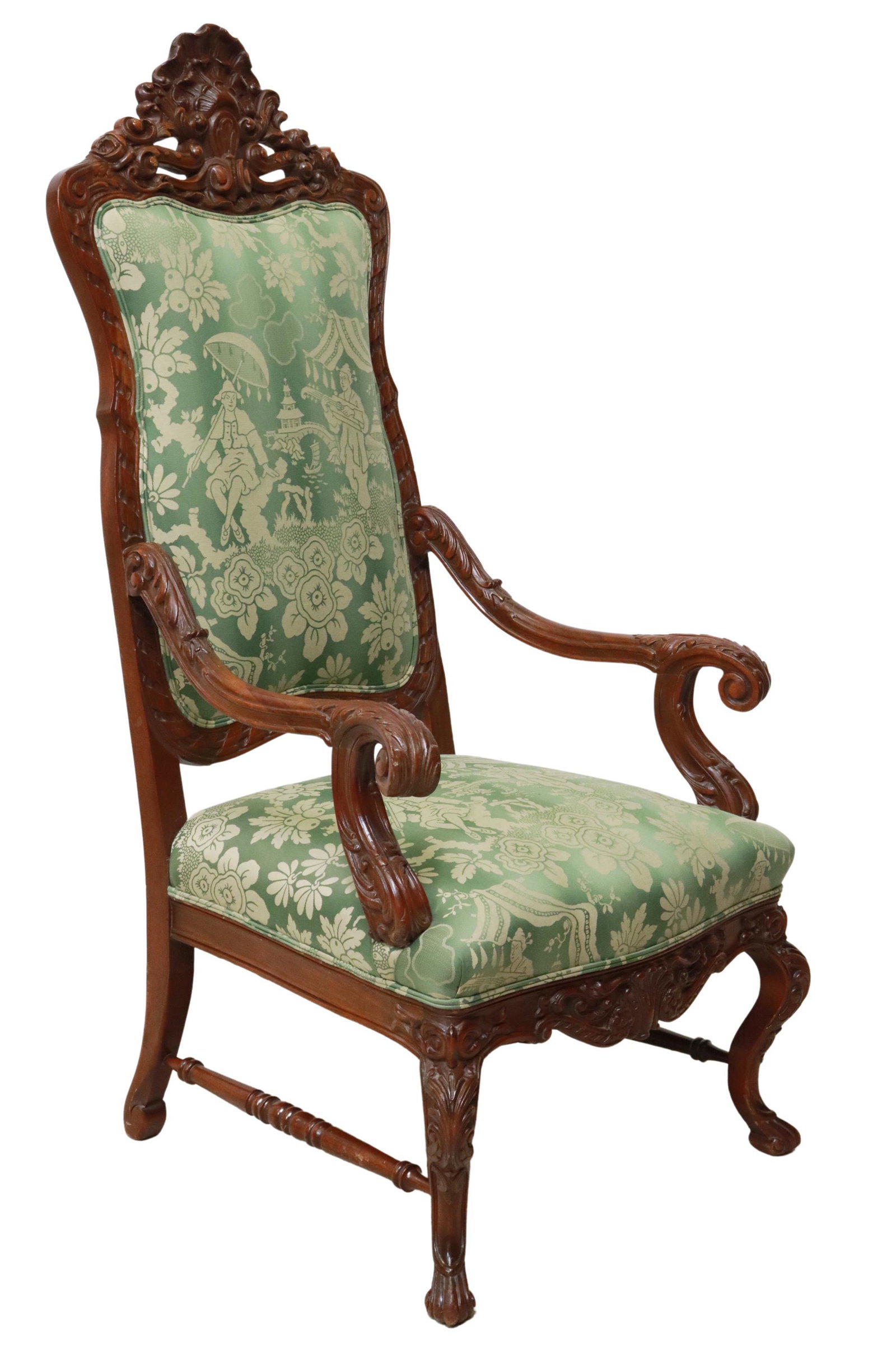 FRENCH ROCOCO STYLE HIGHBACK UPHOLSTERED ARMCHAIR: French Rococo style walnut highback armchair, early 20th c., rocaille carved crest, back and seat in Chinoiserie patterned upholstery, foliated scroll handholds, rising on cabriole stretcher-joined le