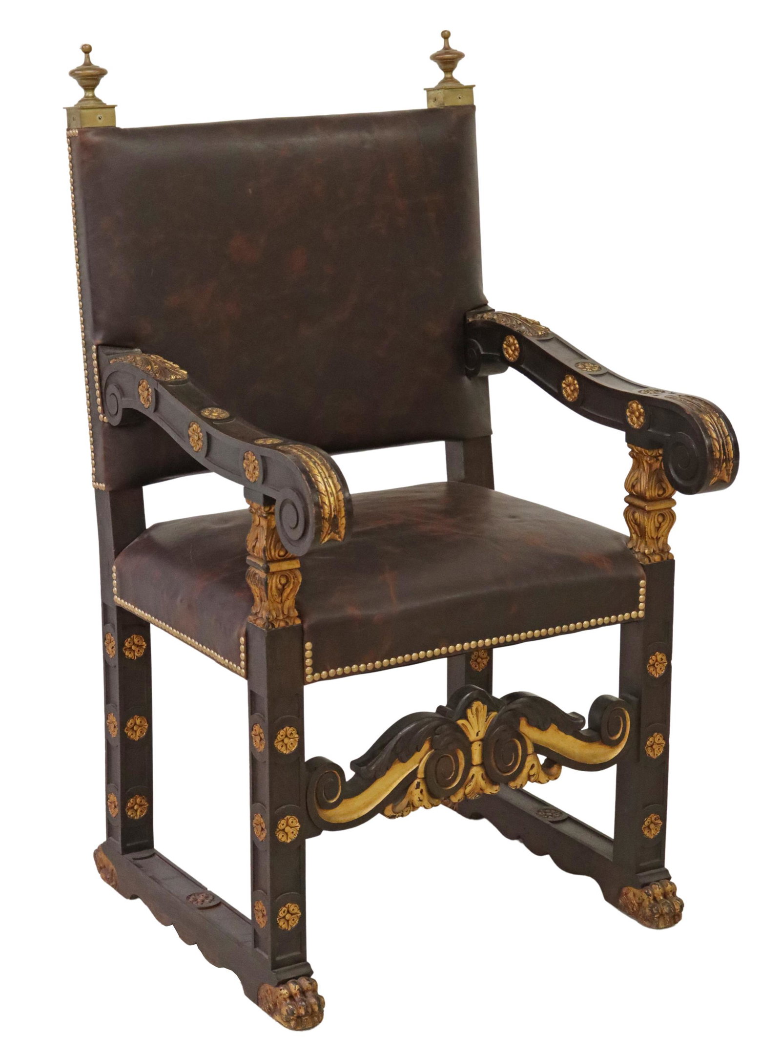 BAROQUE STYLE EBONIZED & PARCEL GILT ARMCHAIR: Baroque style ebonized armchair, 20th c., gilt-metal finials, back and seat in leather upholstery, with nailhead trim, scrolled handholds, over parcel gilt foliate apron, rising on shoe base, ending i