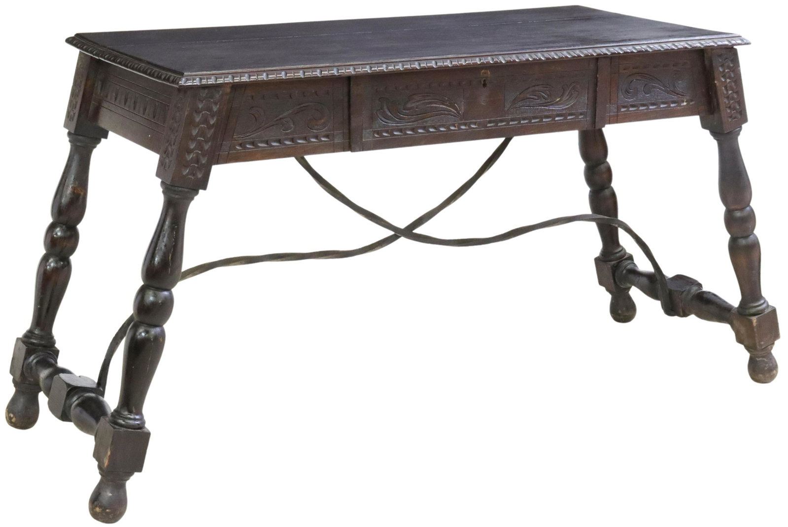 SPANISH BAROQUE STYLE CARVED WRITING DESK: Spanish Baroque style writing desk, late 19th/ early 20th c., carved apron with a single drawer, rising on turned legs, joined by wrought iron cross stretchers, approx 31.25"h, 62"w, 22.5"d Start Pric