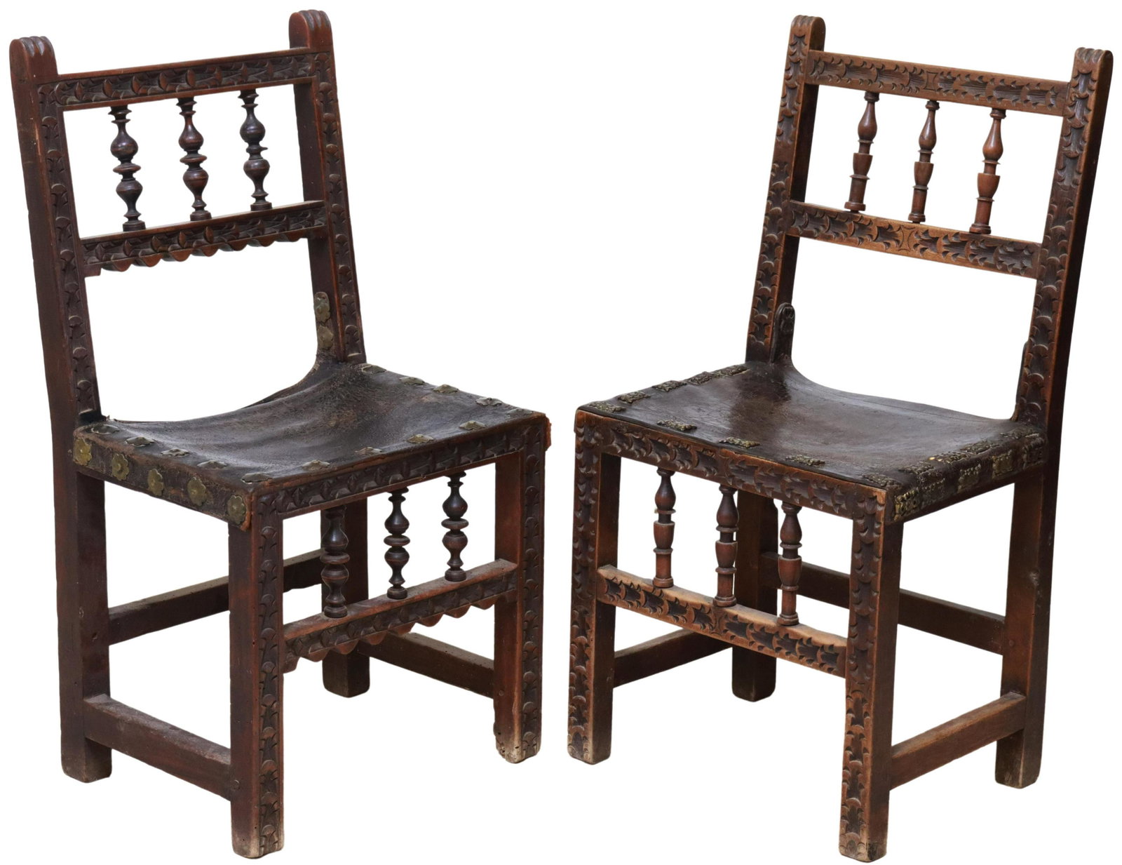 (2) SPANISH BAROQUE STYLE LEATHER SIDE CHAIRS: (lot of 2) Spanish Baroque style side chairs, 19th c., in slightly varied designs and size, both with spindled back, foliate carved frame, leather seat with decorative nailhead trim, rising on stretch