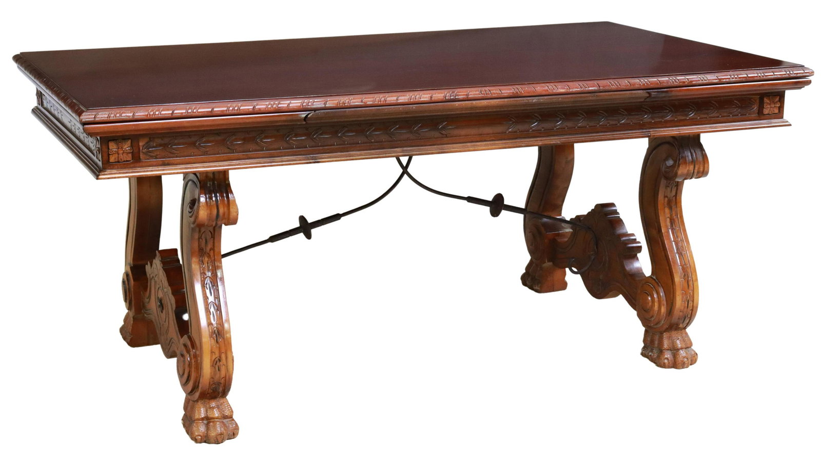 SPANISH DRAW LEAF TABLE WITH IRON CROSS STRETCHERS: Spanish extension table, 20th c., having rectangular top, foliate carved apron, rising on scrolled ox yoke supports, joined with iron cross stretcher, water ring/mark and some surface wear/mars to top
