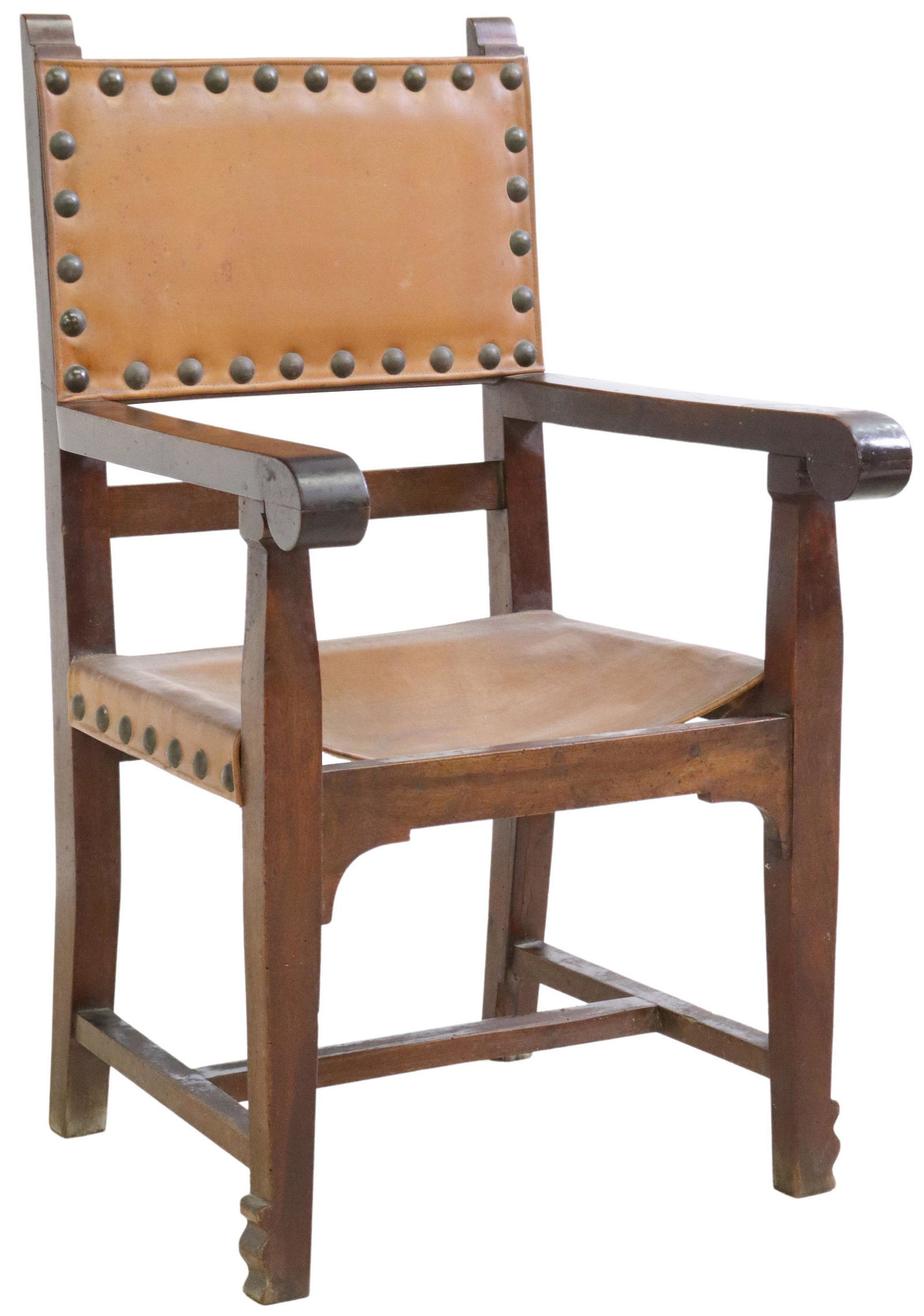 SPANISH BAROQUE STYLE LEATHER ARMCHAIR: Spanish Baroque style armchair, 19th c., leather back and seat with oversized nailhead trim, scrolled handholds, rising on block legs, joined with H-stretcher, ending on shaped feet, approx 44.5"h, 25