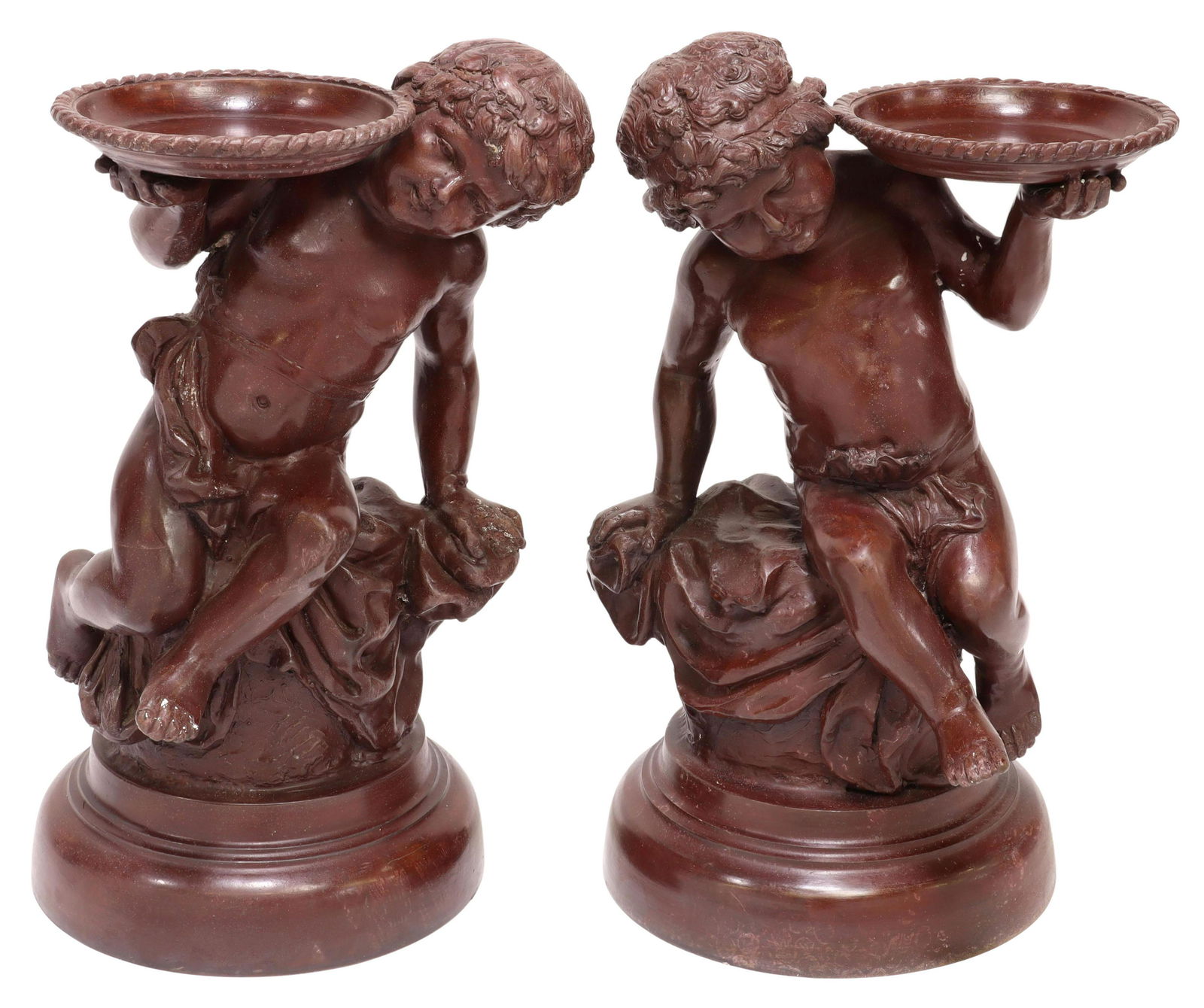 (2) MAITLAND-SMITH BRONZE PUTTI CANDLE HOLDERS: (pair) Maitland-Smith painted bronze candle holders, late 20th c., classical putto holding candle tray, seated on naturalistically modeled support, rising on round pedestal base, approx 16.5"h, 10.5"w