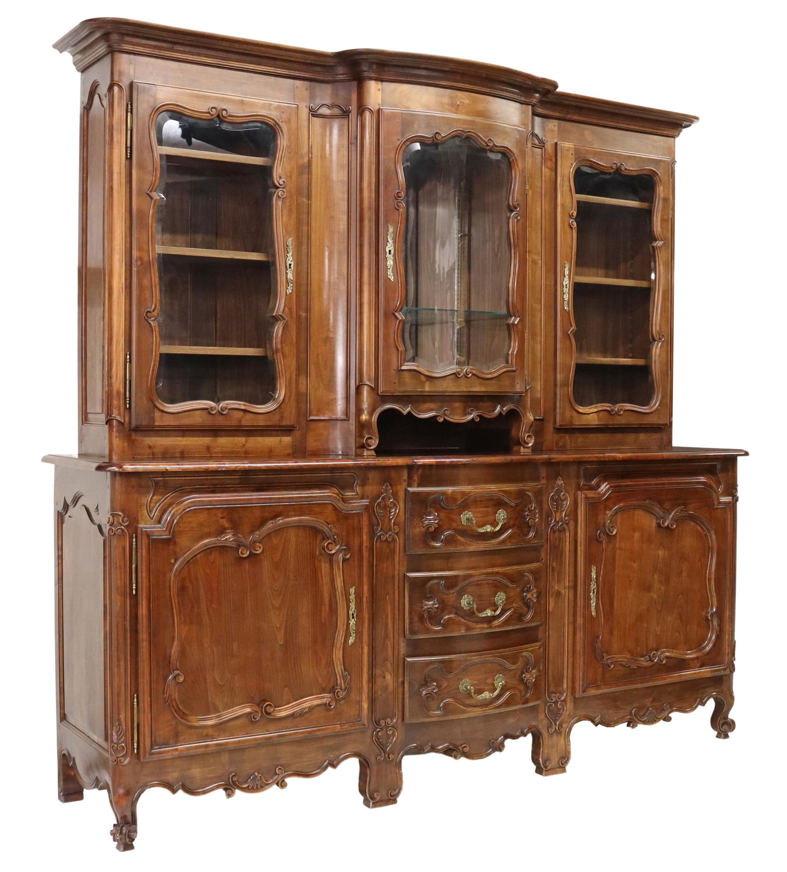 FRENCH LOUIS XV STYLE WALNUT DISPLAY SIDEBOARD: French Louis XV style walnut sideboard, 20th c., having stepped cornice, over three display cabinets with beveled glass doors, center cabinet with mirrored back, lower case fitted with three drawers, 