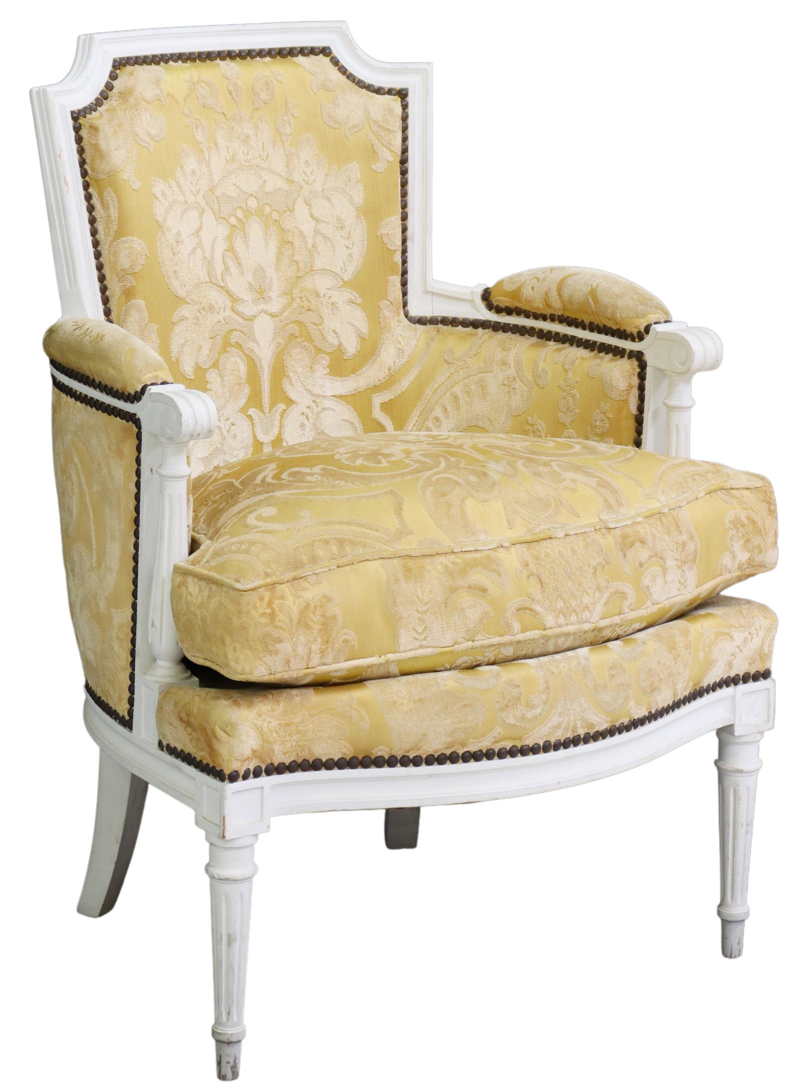 FRENCH LOUIS XVI STYLE PAINTED UPHOLSTERED BERGERE: French Louis XVI style painted armchair, 20th c., shaped back, seat, and arms in damask patterned upholstery, with nailhead trim, scrolled handholds, rising on tapered fluted legs, approx 32.25"h, 23"
