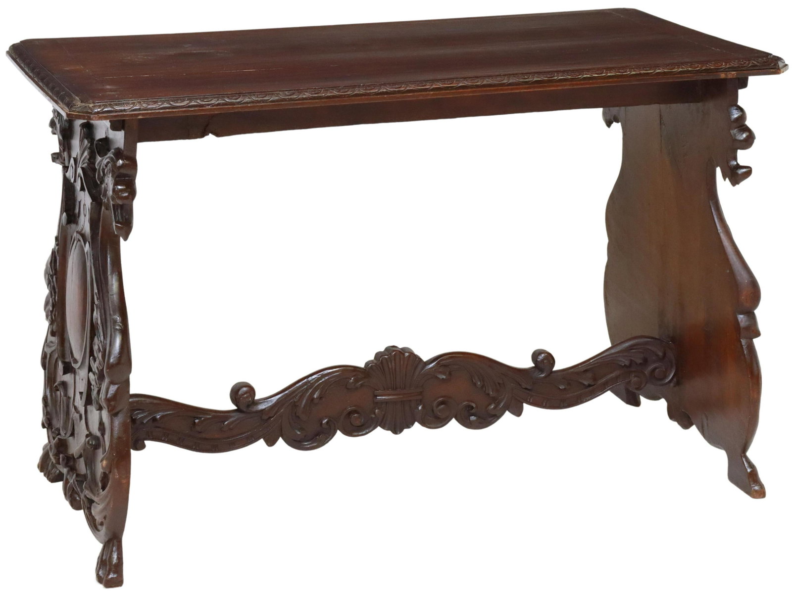 ITALIAN RENAISSANCE REVIVAL CARVED WALNUT TABLE: Italian Renaissance Revival carved walnut table, late 19th c., having rectangular top, over figural trestle base with central shield motif flanked by griffins, joined by cross stretcher, ending in paw