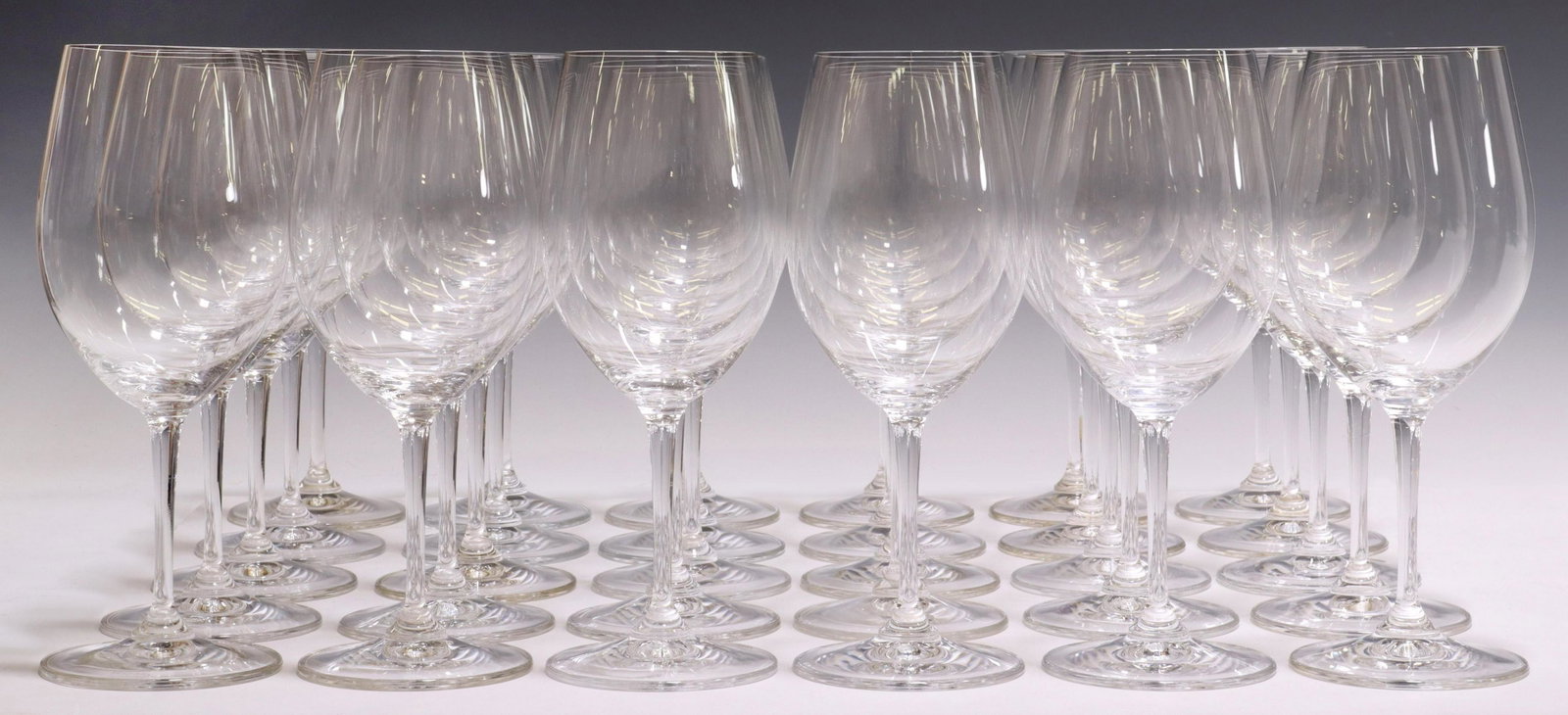(30) RIEDEL COLORLESS GLASS STEMWARE WINE GLASSES: (lot of 30) Riedel colorless glass wine glasses, all having acid-etched maker's mark underfoot, approx 9"h, 2.75" diam, 13.25lbs total Start Price: $100.00