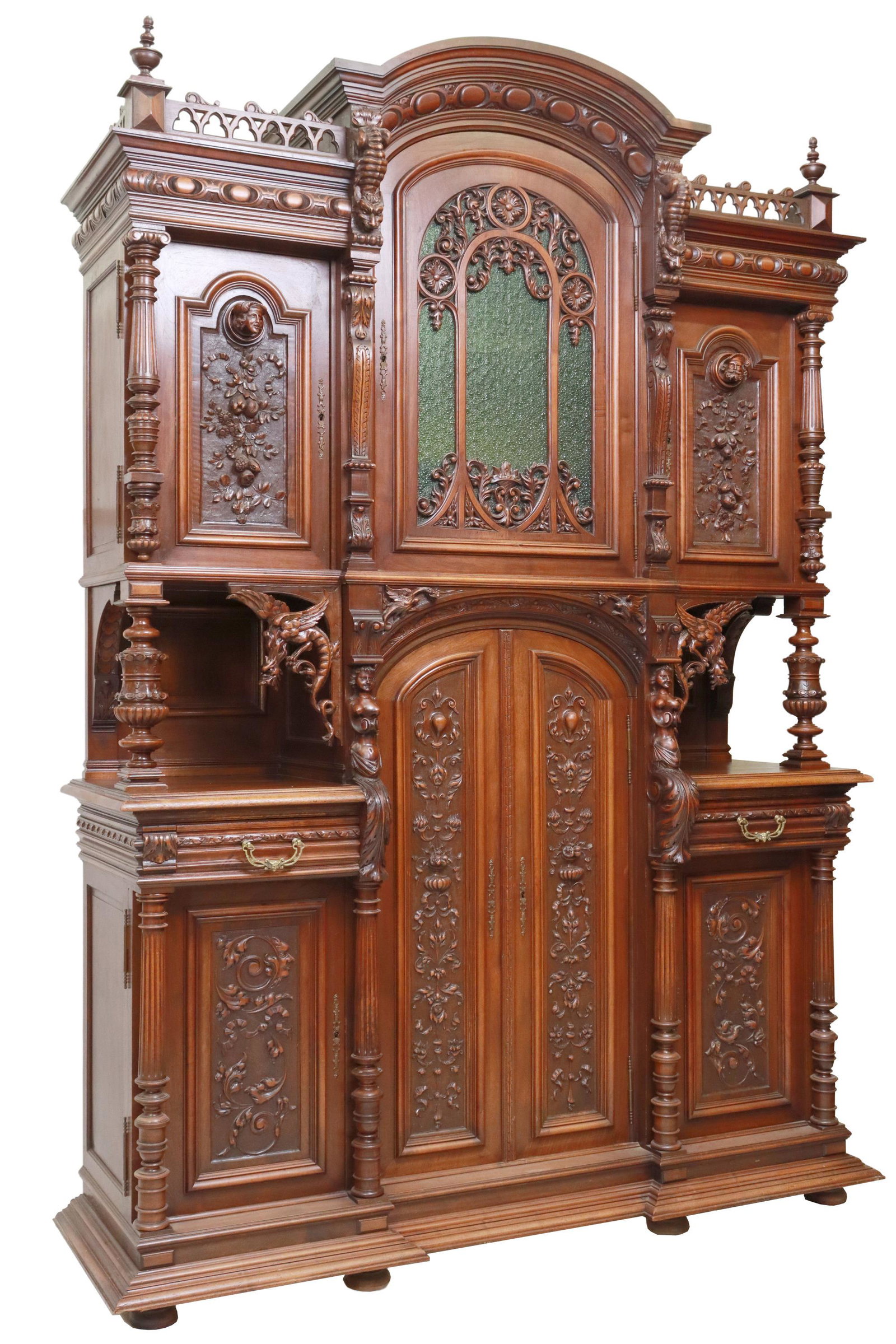 FRENCH HENRI II STYLE CARVED WALNUT SIDEBOARD: French Henri II style carved walnut sideboard, late 19th/ early 20th c., having molded cornice, trefoil arcaded gallery, the whole carved with scrolling foliates and protruding figures throughout, upp