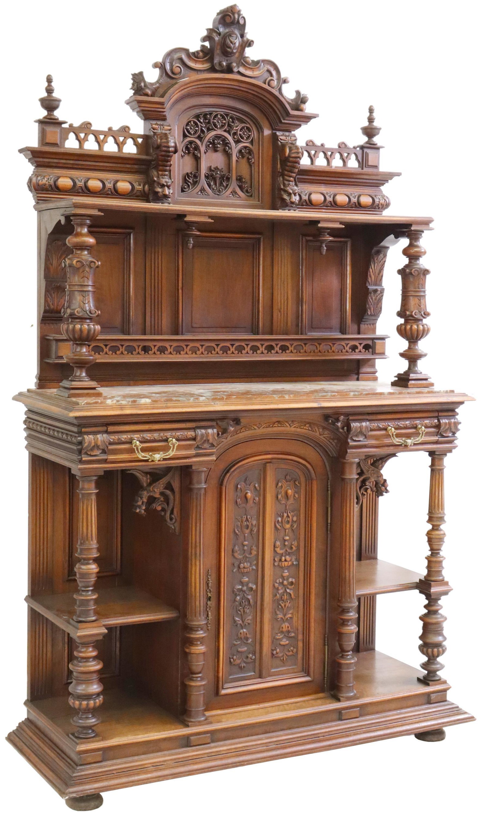 FRENCH HENRI II STYLE CARVED WALNUT SIDEBOARD: French Henri II style walnut sideboard, late 19th/ early 20th c., having cartouche and cornucopia crest, over top gallery, heavily carved and featuring mythic beasts, lower gallery with inset marble t
