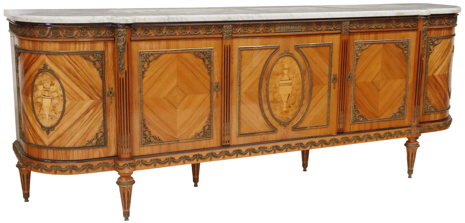 J.P. EHALT LOUIS XVI STYLE MARBLE-TOP SIDEBOARD: French Louis XVI style marble-top matched veneer sideboard, Jean-Pierre Ehalt, late 20th c., foliated urn marquetry, gilt metal rinceau mounts, five cabinet doors, including a bowfront door at each en