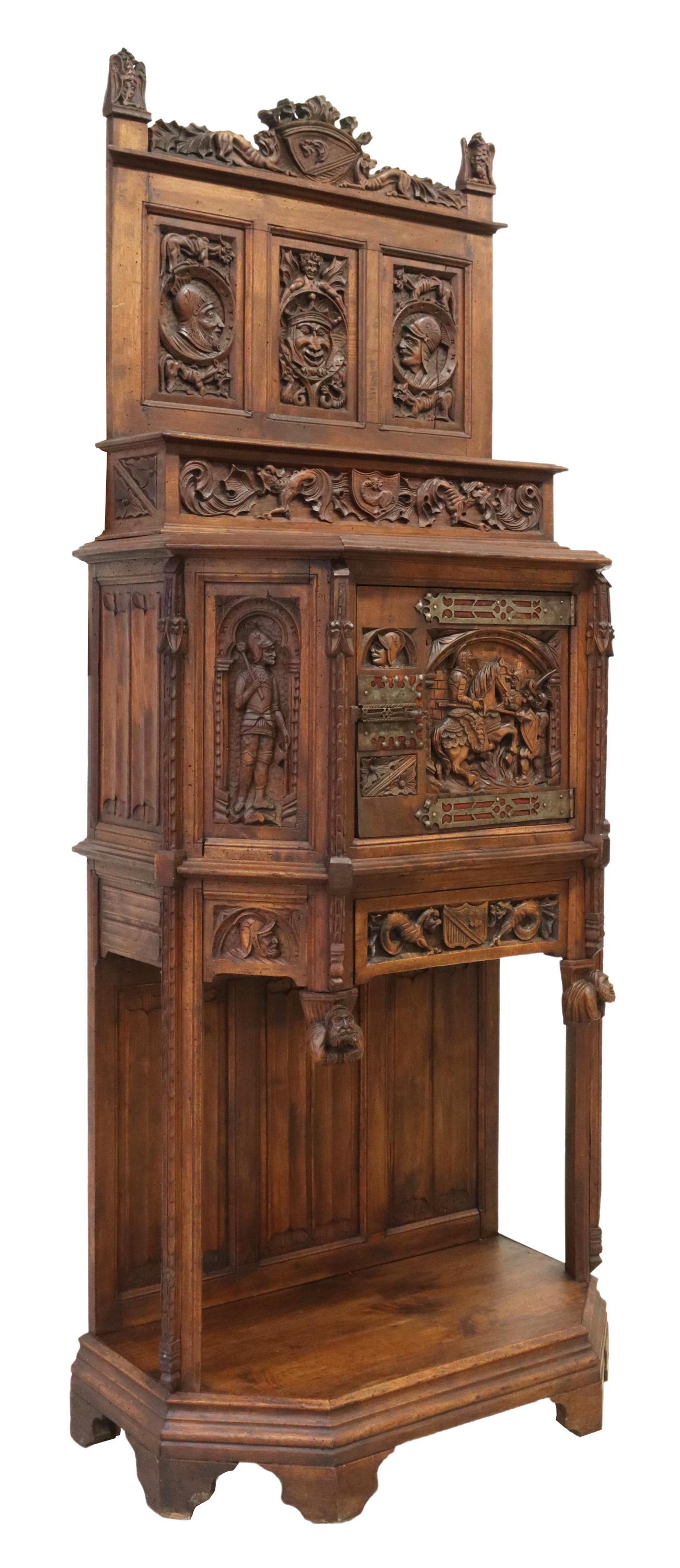 FRENCH GOTHIC REVIVAL CARVED OAK CUPBOARD CABINET: French Gothic Revival oak cupboard cabinet, early 19th c., having carved dragon crest, flanked by falcon finials, figural back panels, open shelf, over canted case carved with linenfold to sides, knig