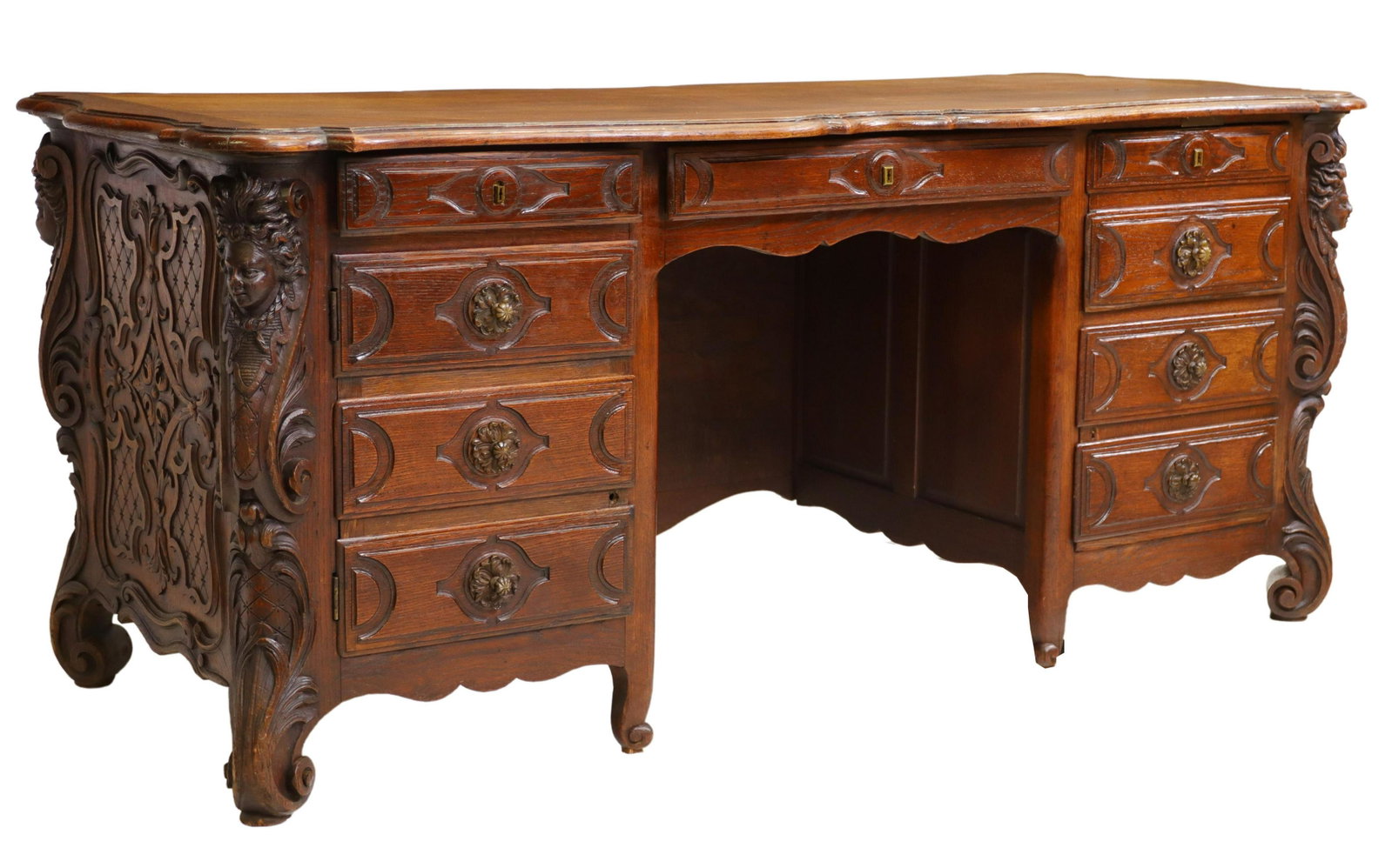 EXCEPTIONAL FRENCH LOUIS XV STYLE CARVED OAK DESK: French Louis XV style oak writing desk, 19th c., having shaped top, over central drawer, flanked by single drawer and cabinet to the left, compartment drawer and cabinet to the right, carved caryatid 