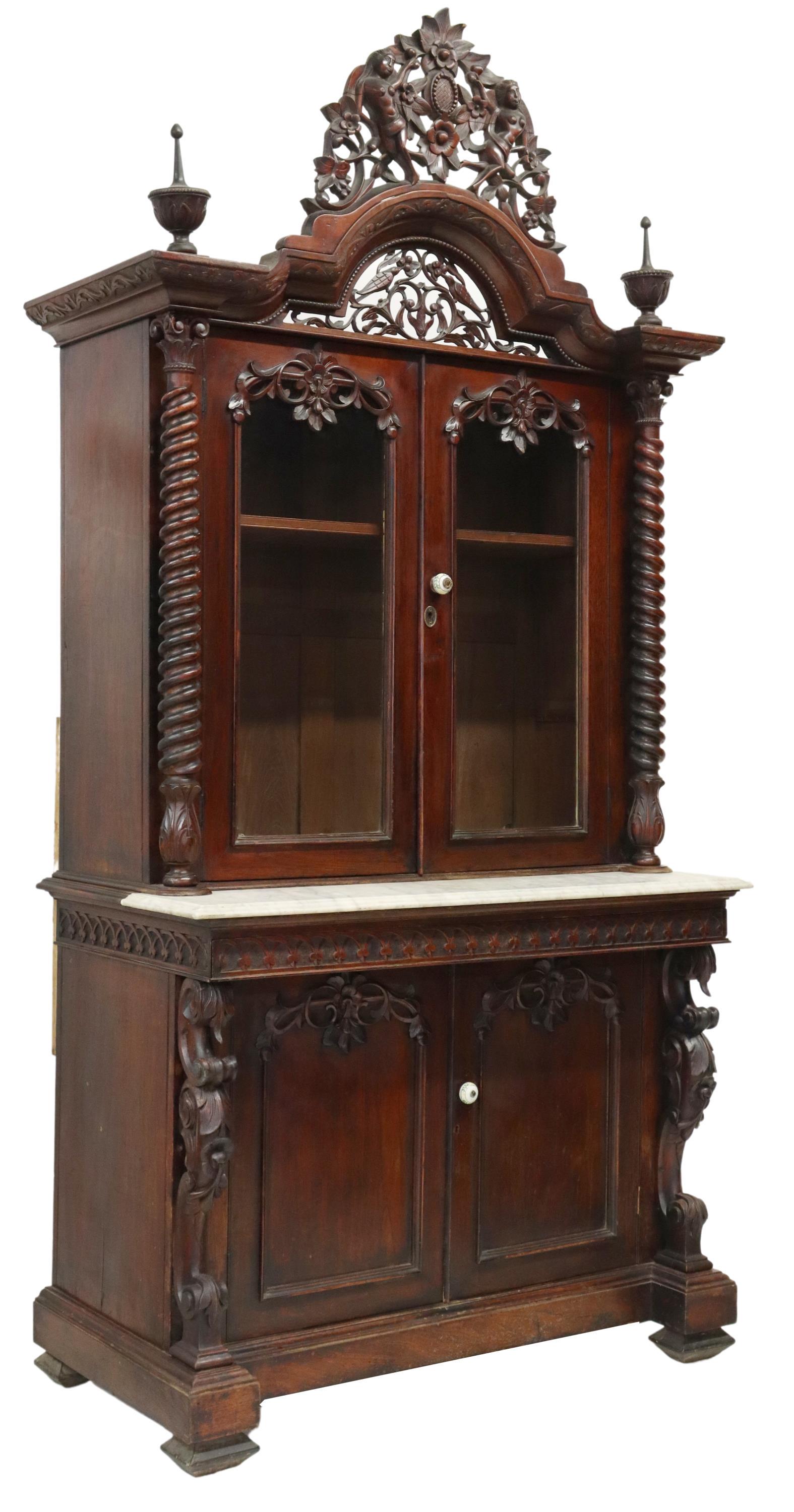BRITISH COLONIAL ROSEWOOD BOOKCASE CABINET: British Colonial rosewood bookcase cabinet, 19th c., pierced floral crest, with carved female figures, over dual glazed doors, opening to shelved interior, flanked by twist columns, over lower case, h