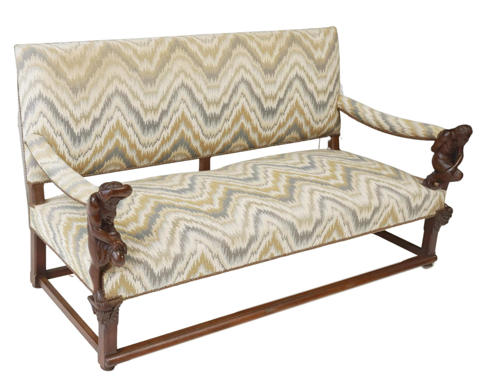 FRENCH FIGURAL CARVED WALNUT SETTEE SOFA: French carved walnut sofa/ settee, 19th c., flame stitch pattern upholstery, arms terminating in crouching Atlas, over winged cherub mask, rising on stretcher-joined legs, approx 37.5"h, 69.5"w, 34"d 