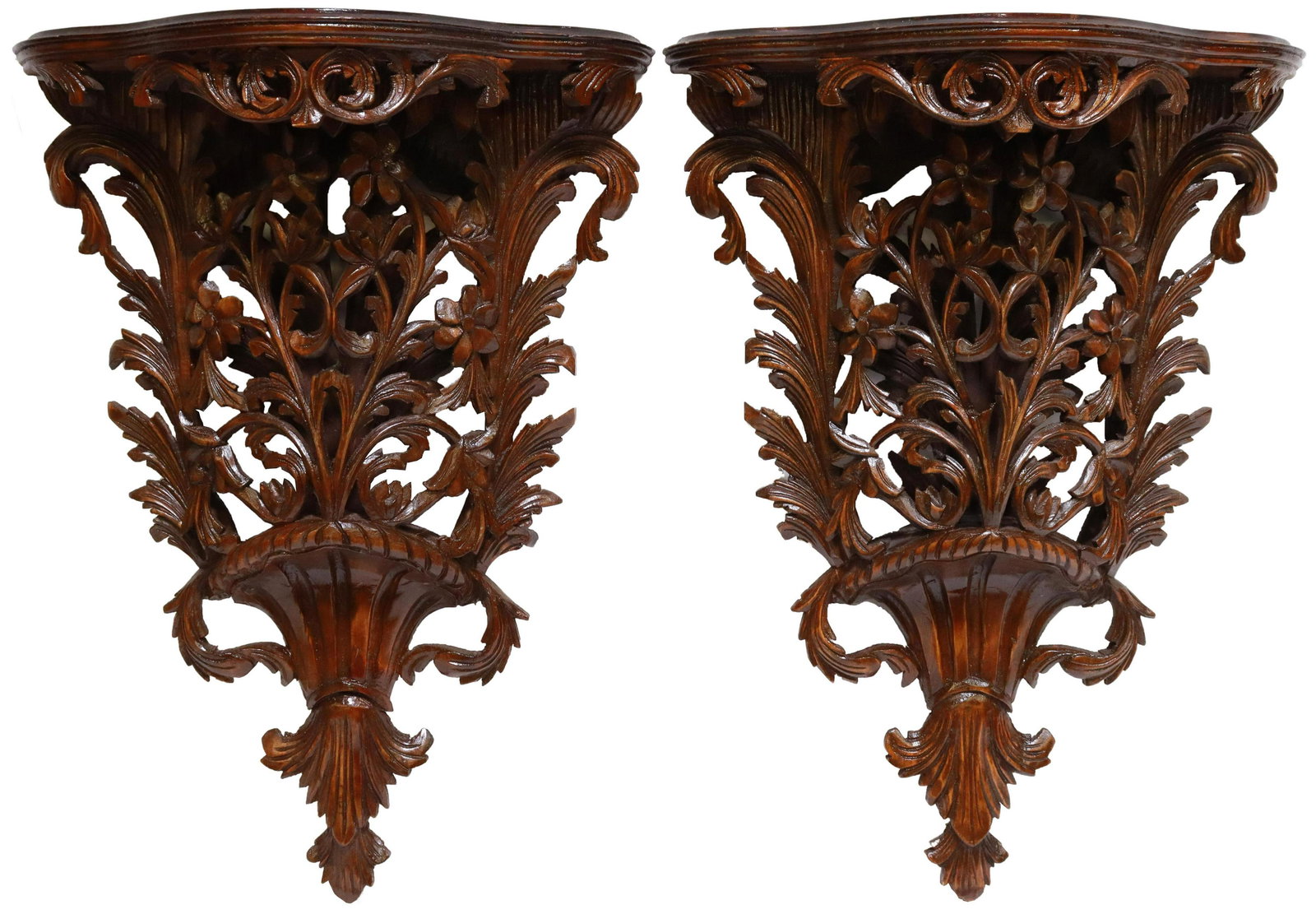 (2) ITALIAN ELABORATELY CARVED WOOD WALL BRACKETS: (lot of 2) Italian lacquered and carved wood wall brackets, 20th c., having shaped top with stepped cornice, foliate apron, over pierced floral carving, (one) with restoration to lower foliate scroll,