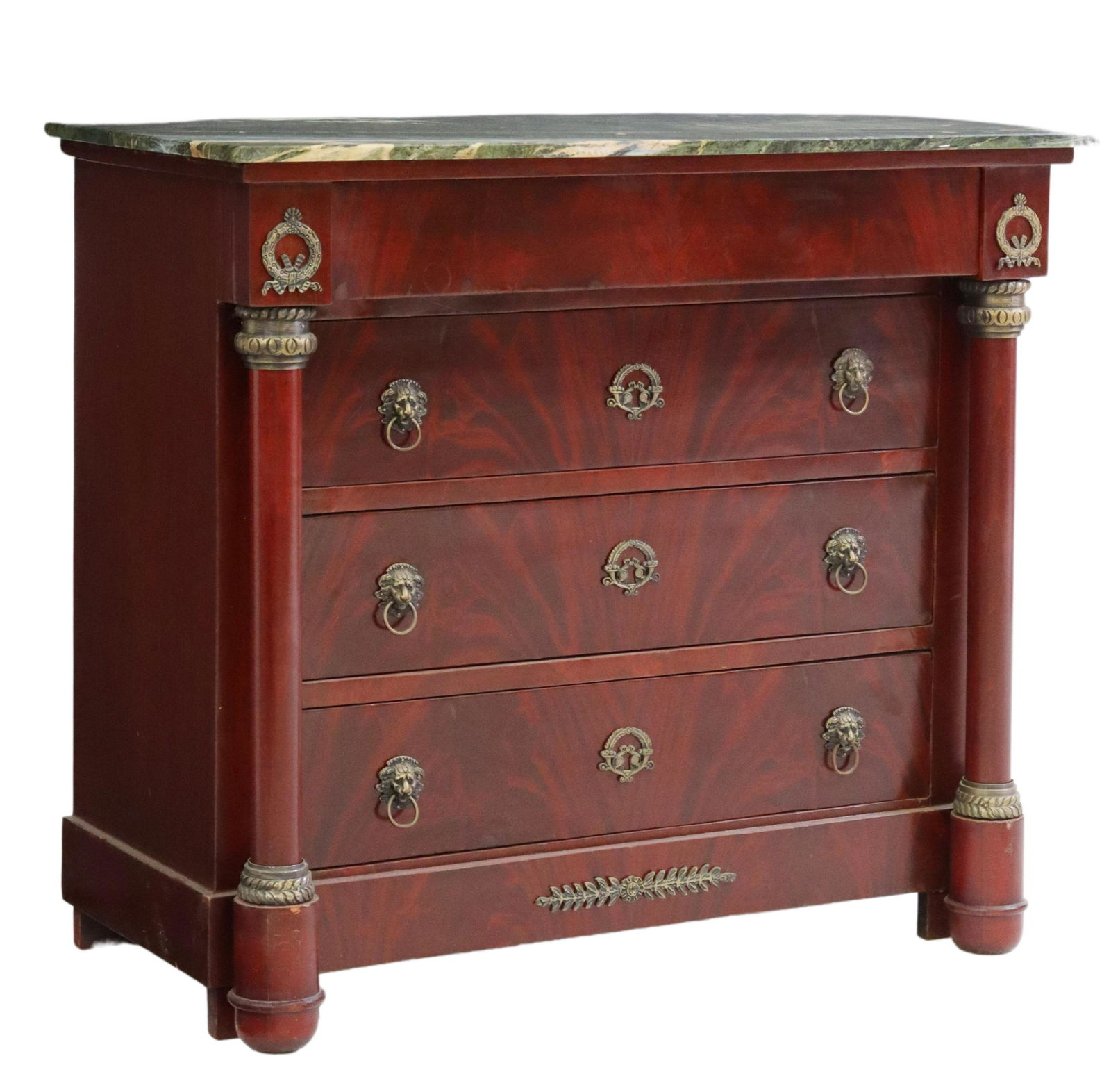 FRENCH EMPIRE STYLE MARBLE-TOP MAHOGANY COMMODE: French Empire style flame mahogany commode, early 20th c., having marble top, protruding frieze drawer, over three additional drawers, with lion head pulls, flanked by turned columns, rising on cup fe