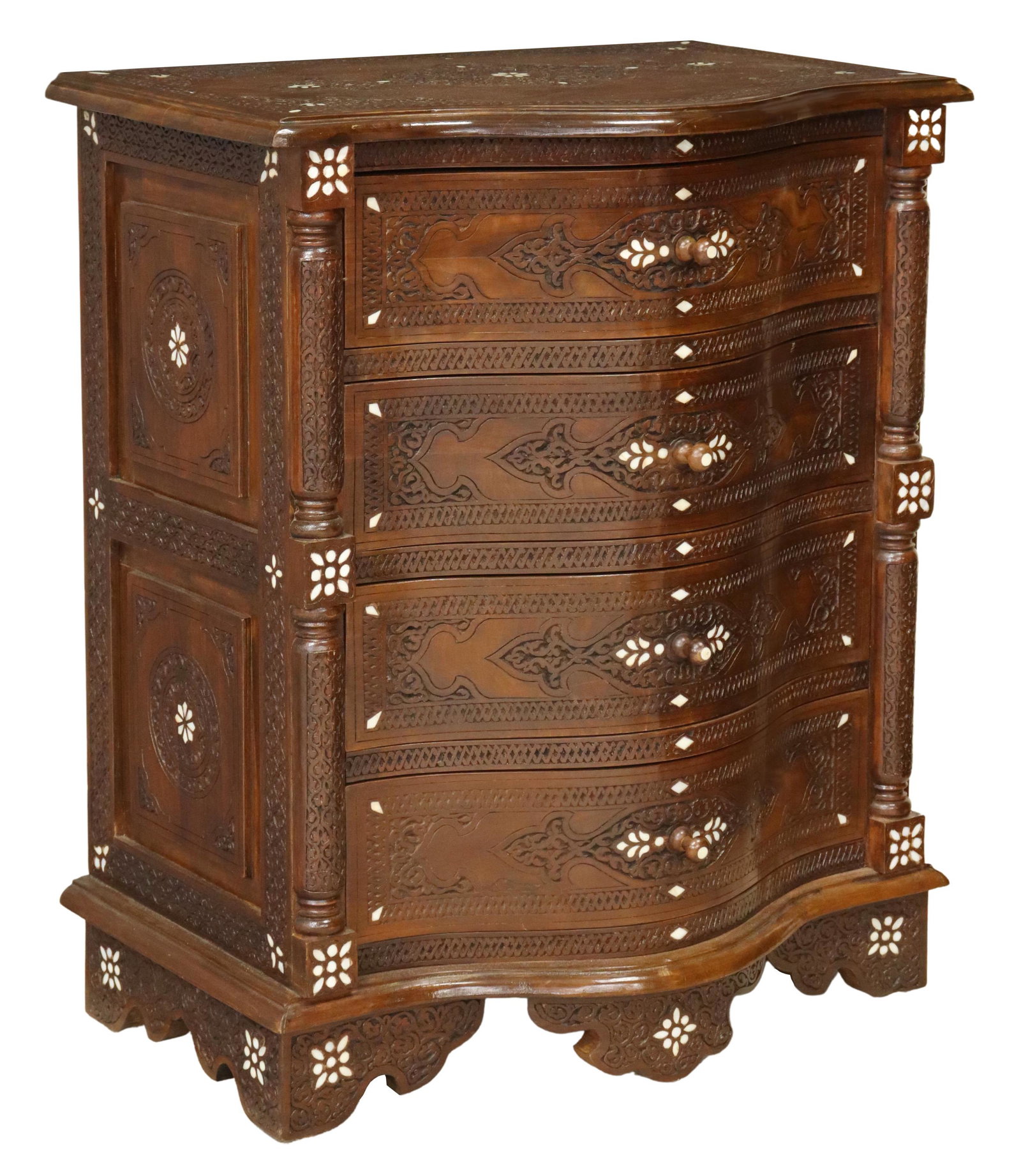 SYRIAN CARVED WOOD & MOTHER-OF-PEARL INLAID CHEST: Syrian carved wood and mother of pearl inlaid chest, Wunderley Furniture, 20th c., having shaped top, over conforming case fitted with four drawers, flanked by carved corner posts, rising on bracket f